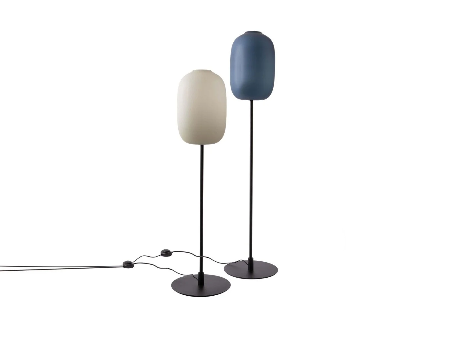 Two modern floor lamps with oval-shaped shades, one white and one blue, on black stands with flat circular bases, connected by visible electrical cords.