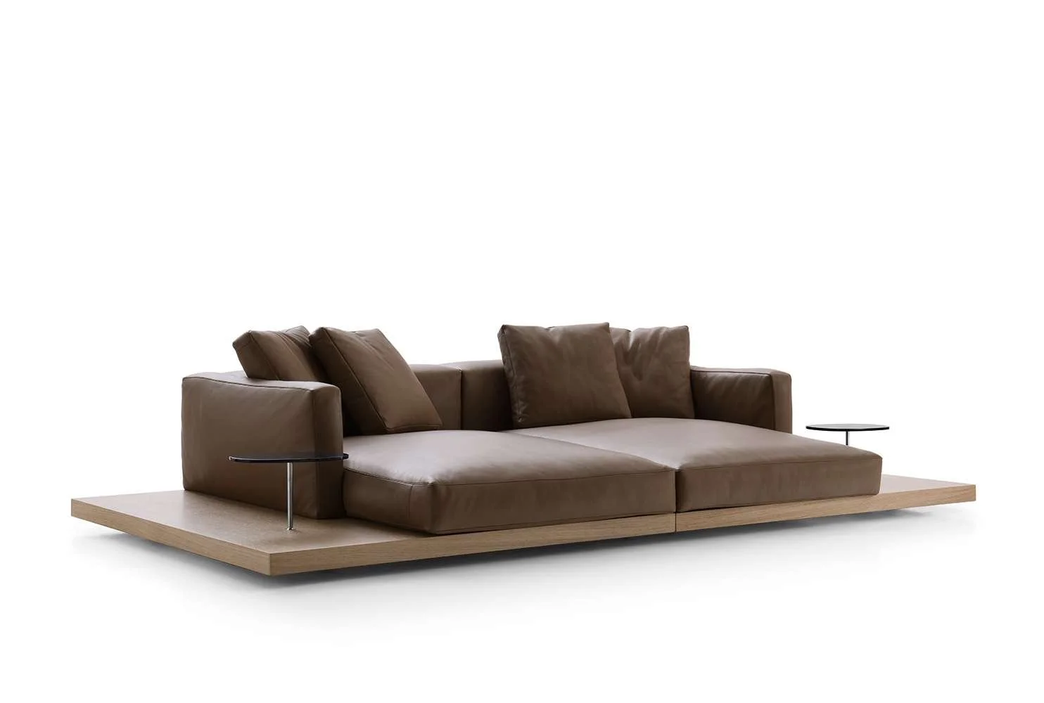 Modern brown leather sofa with two built-in side tables on a wooden platform, set against a white background.