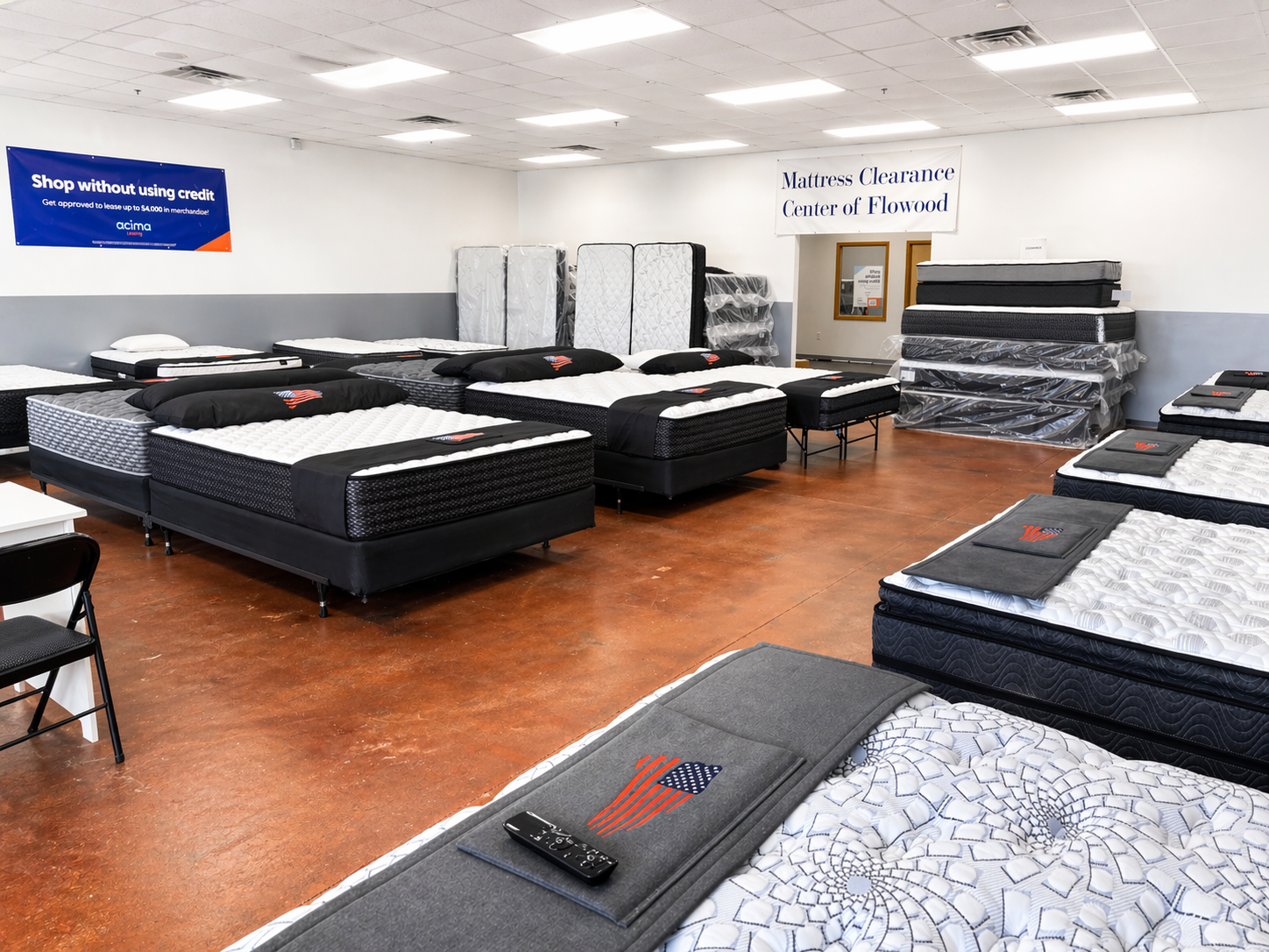 Store display of various mattresses stacked and arranged for sale in a mattress clearance center.