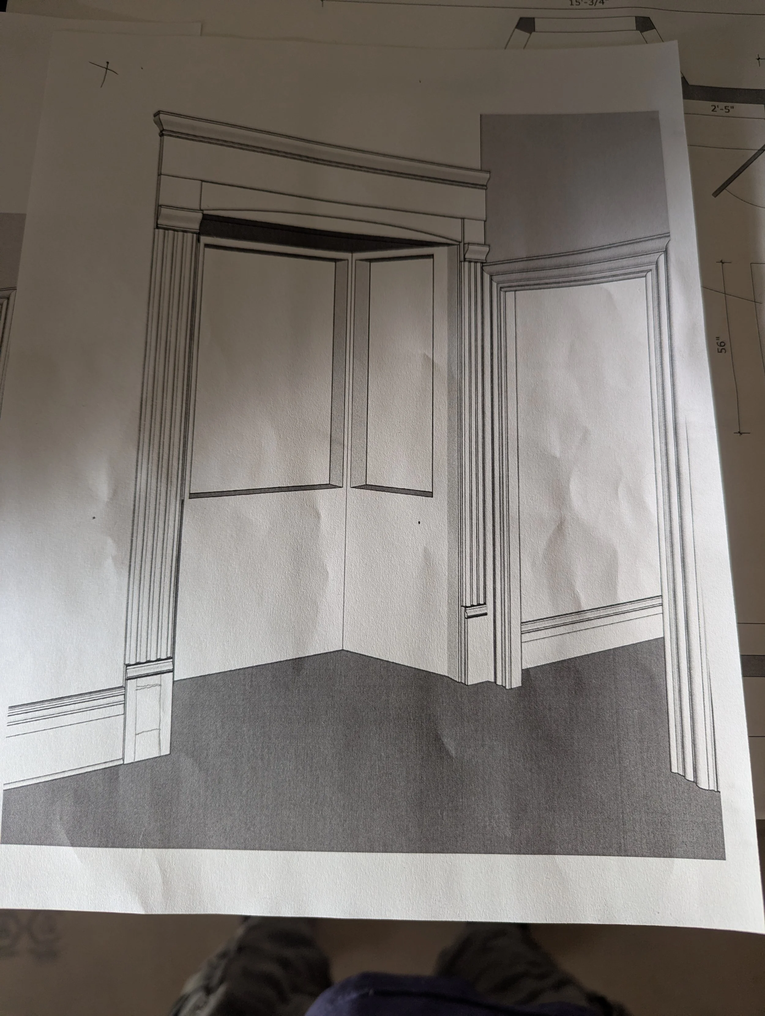Architectural design drawing of a room corner with crown molding around the ceiling, detailed door framing, and built-in paneling on the wall.
