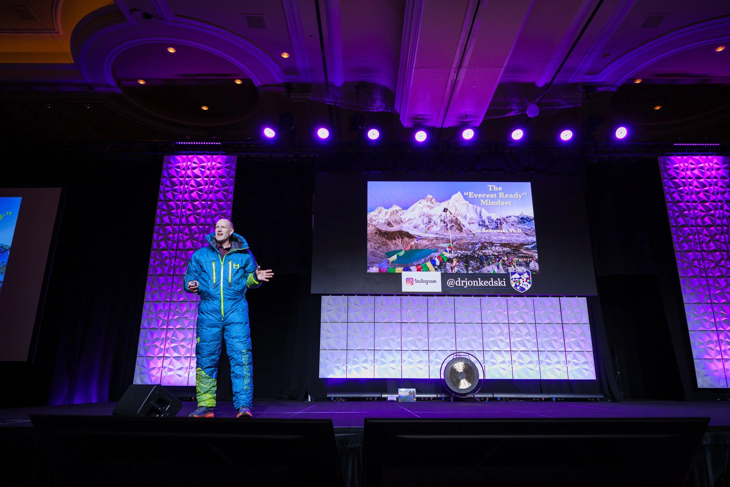 Dr. Jon Kedrowski wearing his summit suit, delivering 'The Everest Ready Mindset' keynote to Gong AI.