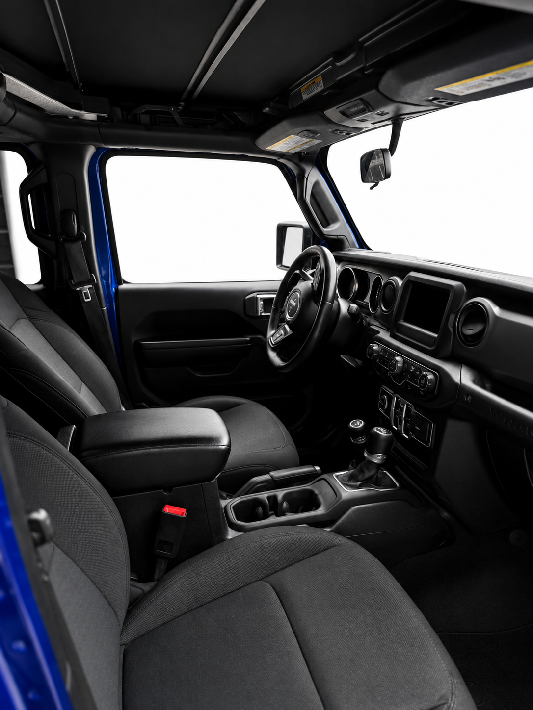 Interior of a modern vehicle showcasing the steering wheel, dashboard, gear shift, and front seats with center console.