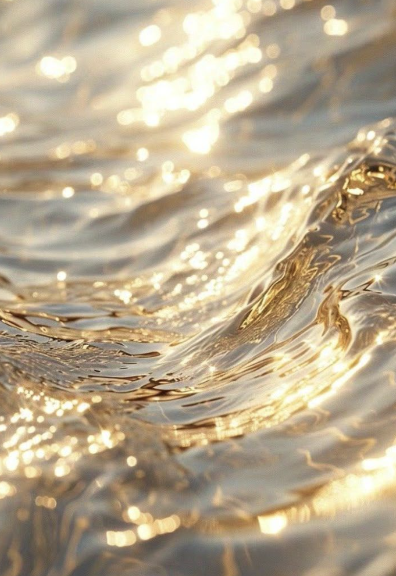 Close-up of a water surface shimmering in sunlight with ripples and reflections.