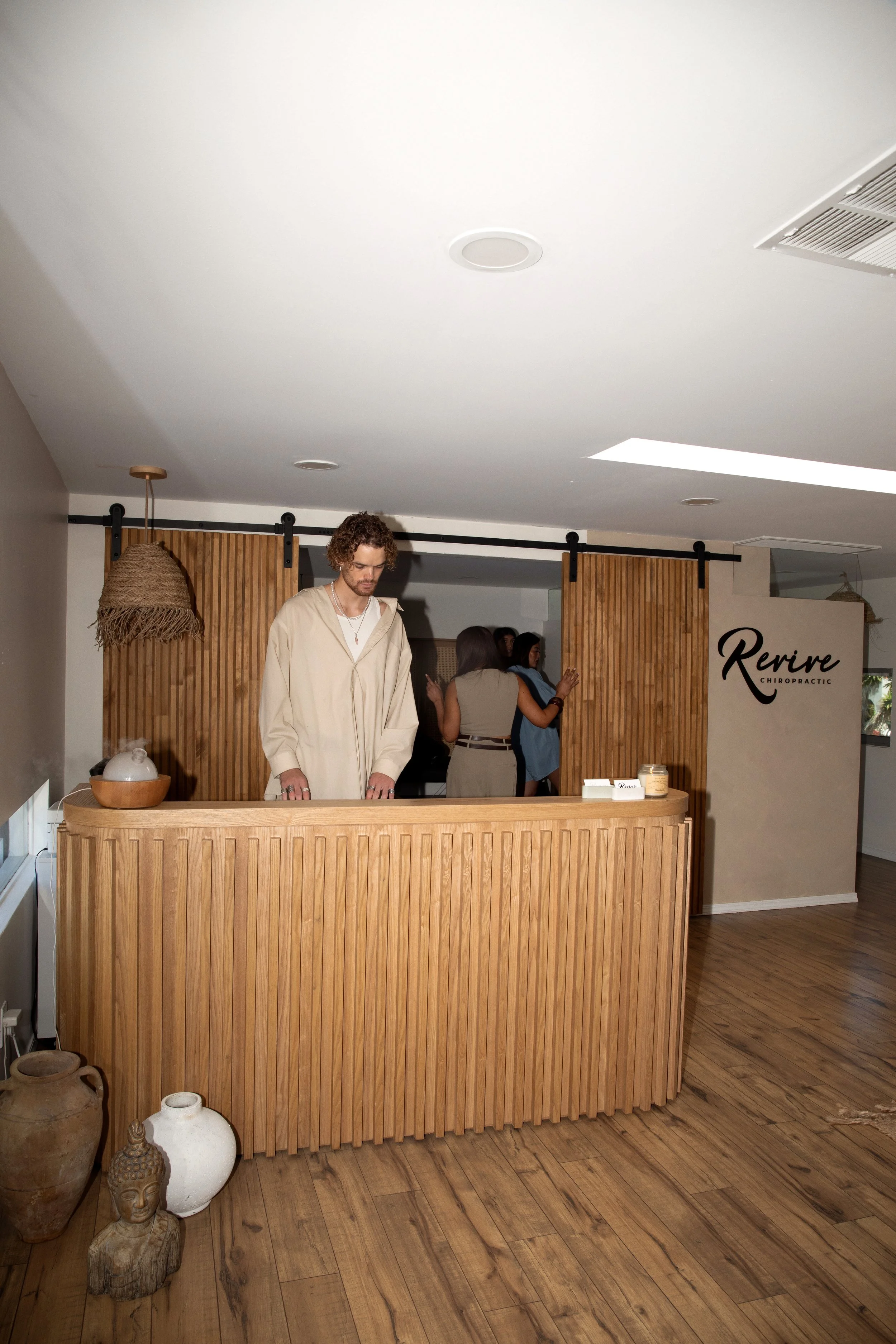 Host greeting guests at the Revive reception during a private event, San Diego