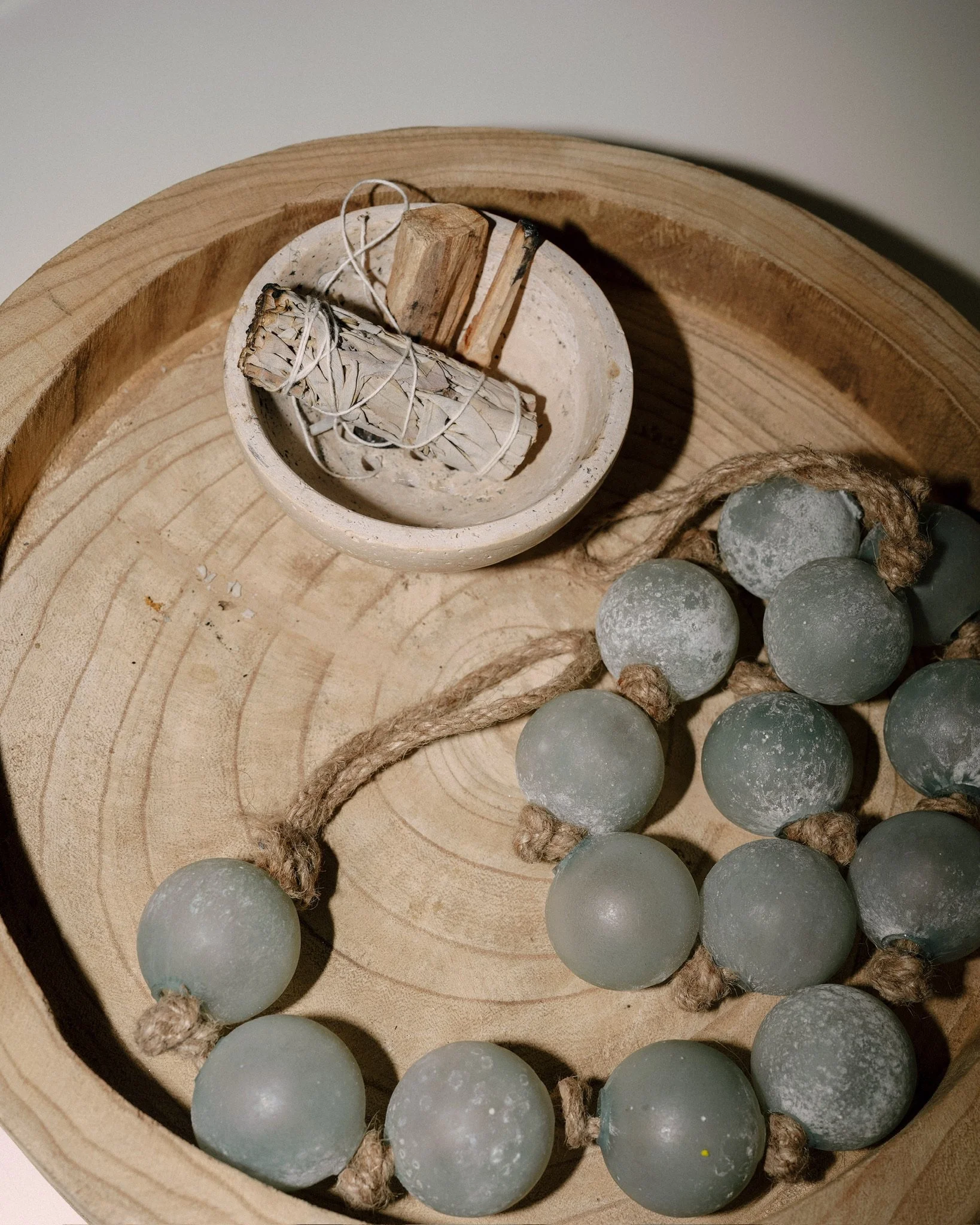 Sage and palo santo in a wooden bowl at Revive Chiropractic in Point Loma, San Diego
