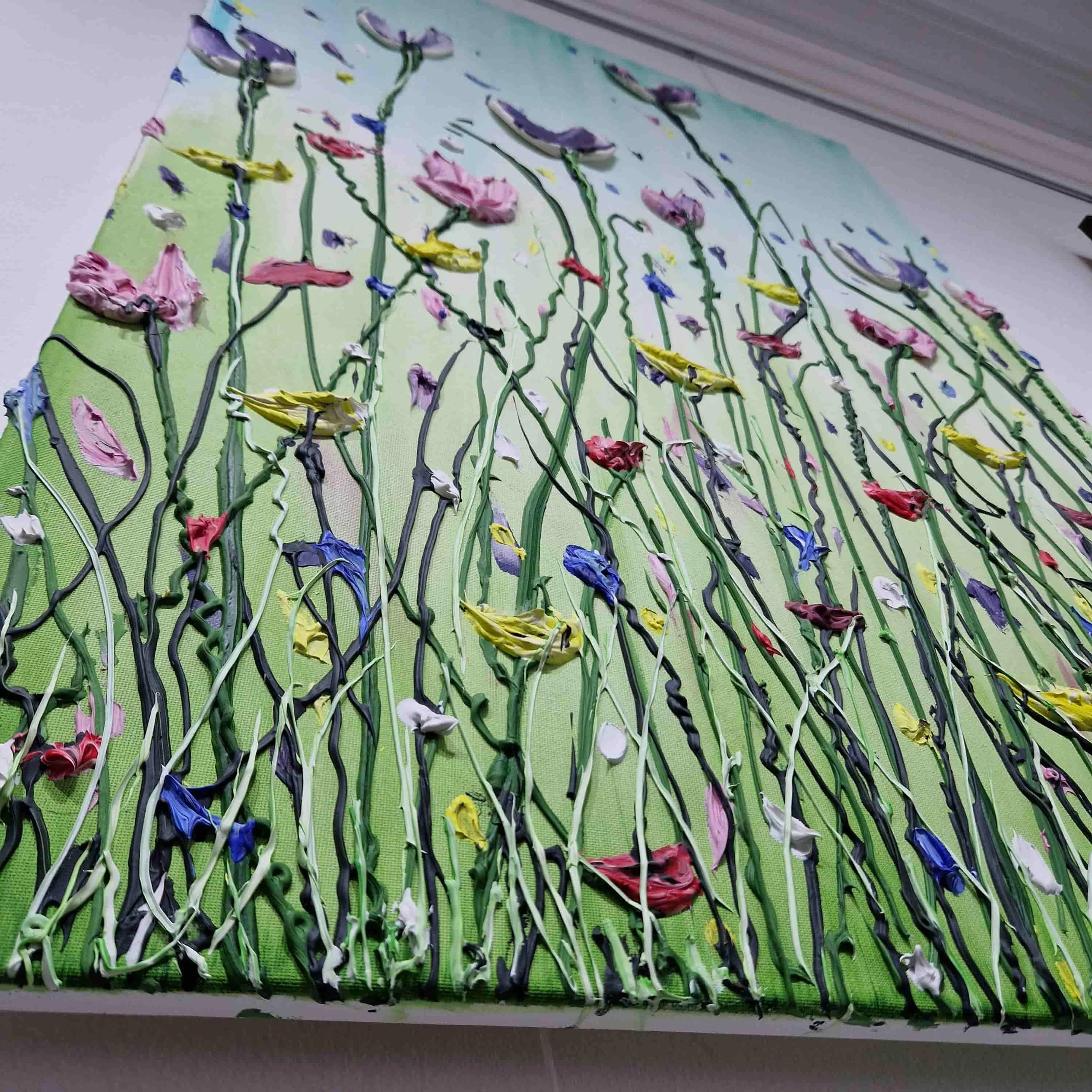 A textured abstract art piece with thick, textured brushstrokes of vibrant colors, including pink, purple, blue, yellow, white, and green, arranged in vertical wavy lines on a predominantly light green background.