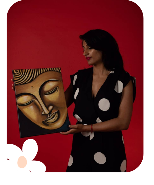Woman holding a painting of a Buddha face against a red background.