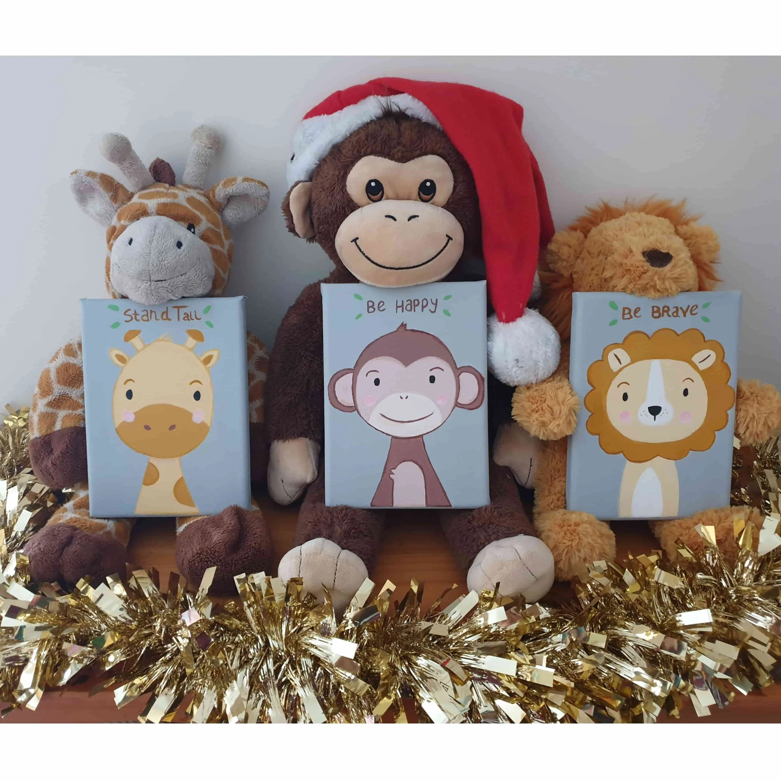 Gold and silver tinsel surrounding stuffed animal monkeys and other plush toys on display.
