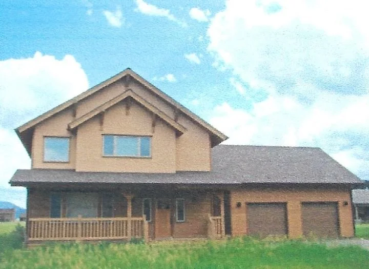 A two-story house with a front porch and three garage doors, surrounded by green grass and a partly cloudy sky.