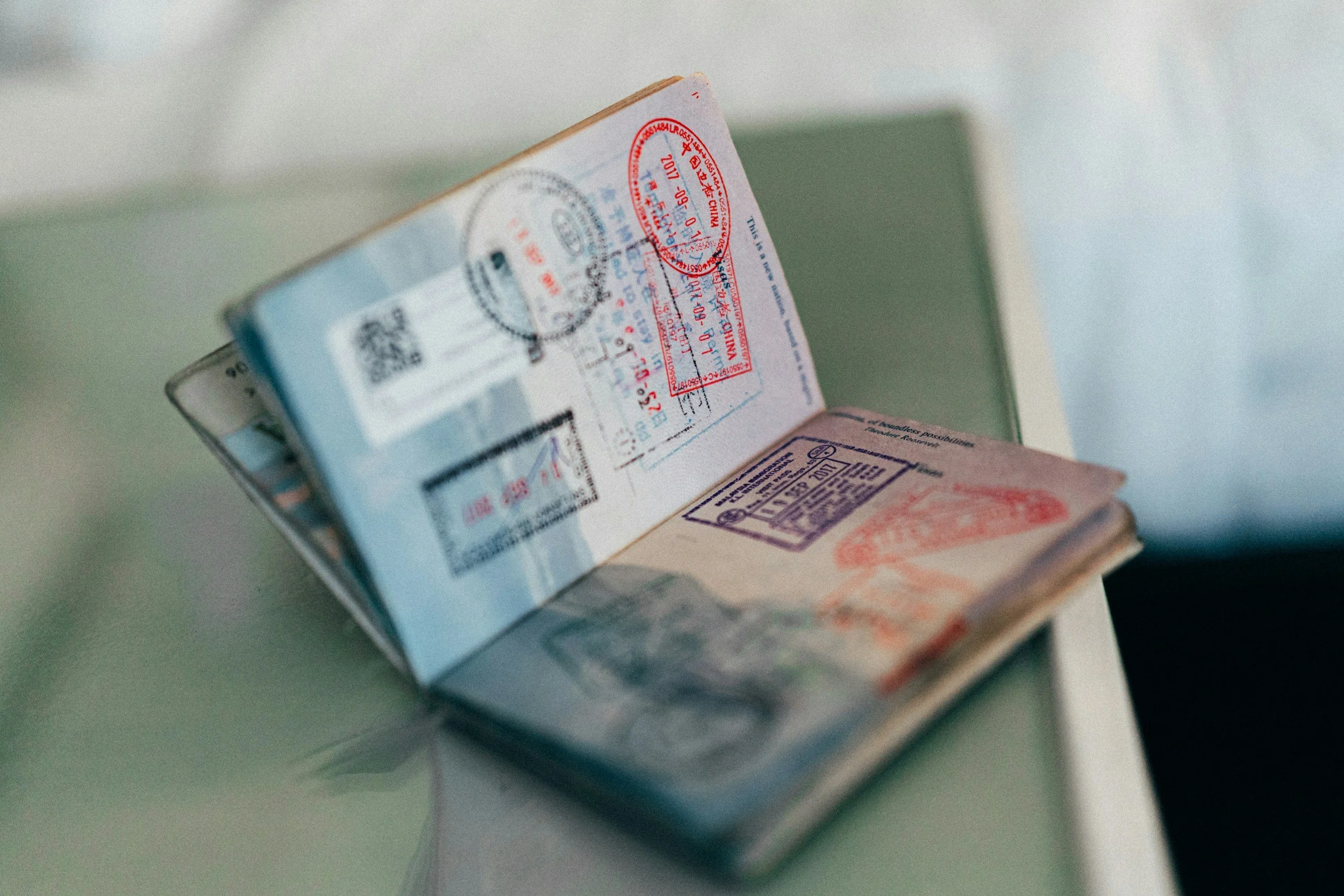 Open passport showing colorful travel stamps and visas representing international travel