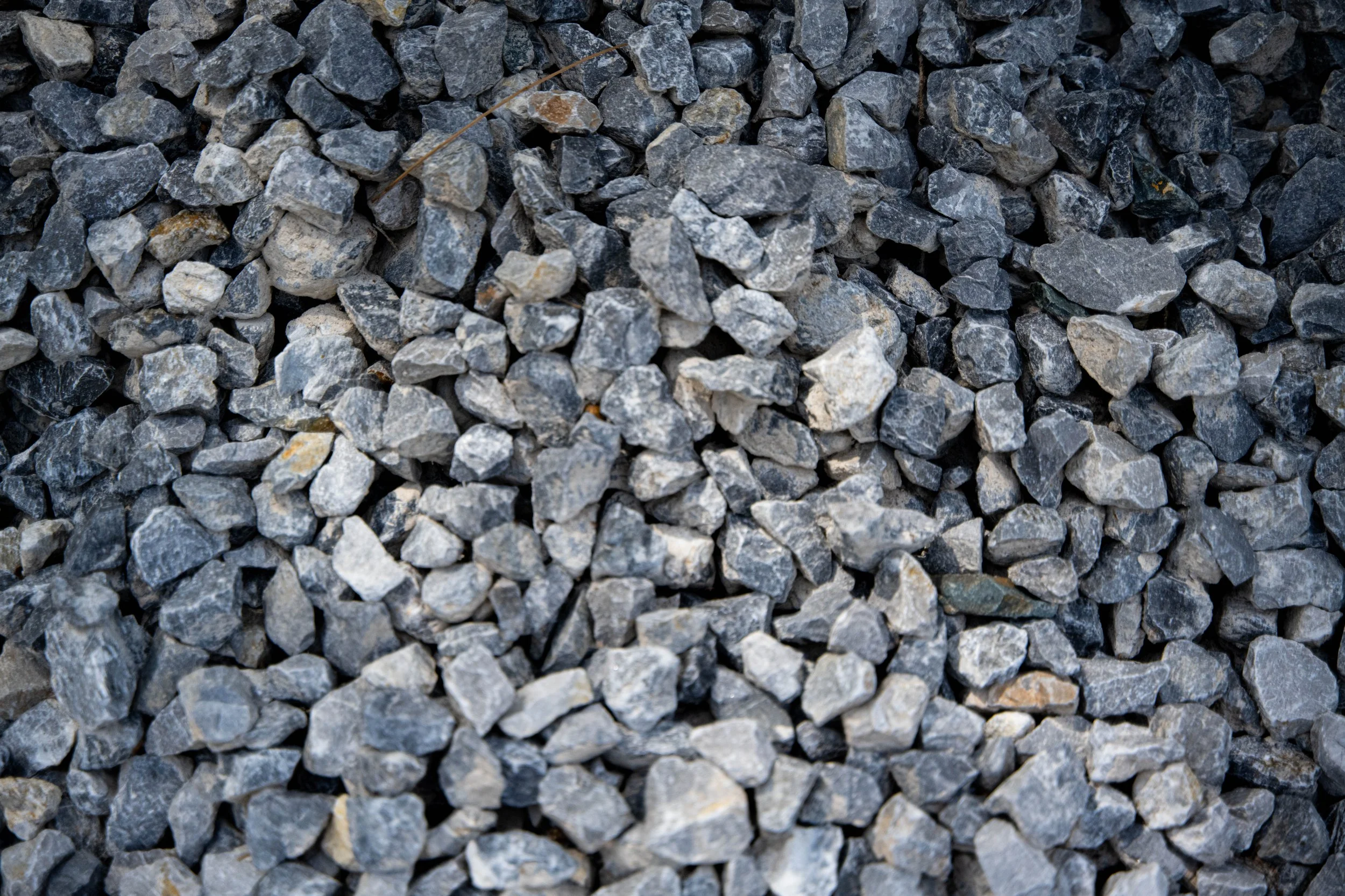 Close-up of a pile of medium-sized gray and black gravel stones.