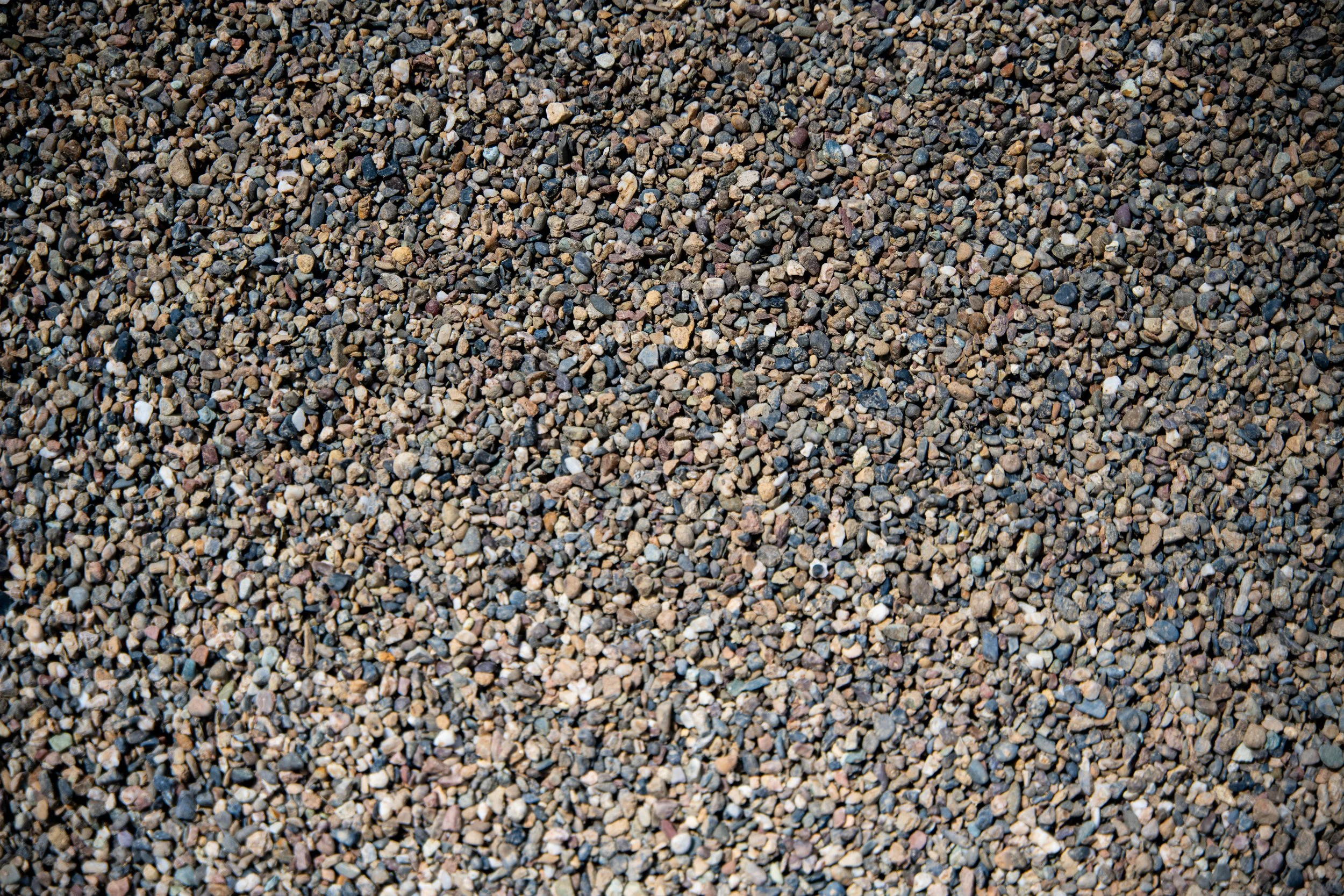 Close-up of a densely packed layer of small, multicolored gravel stones.