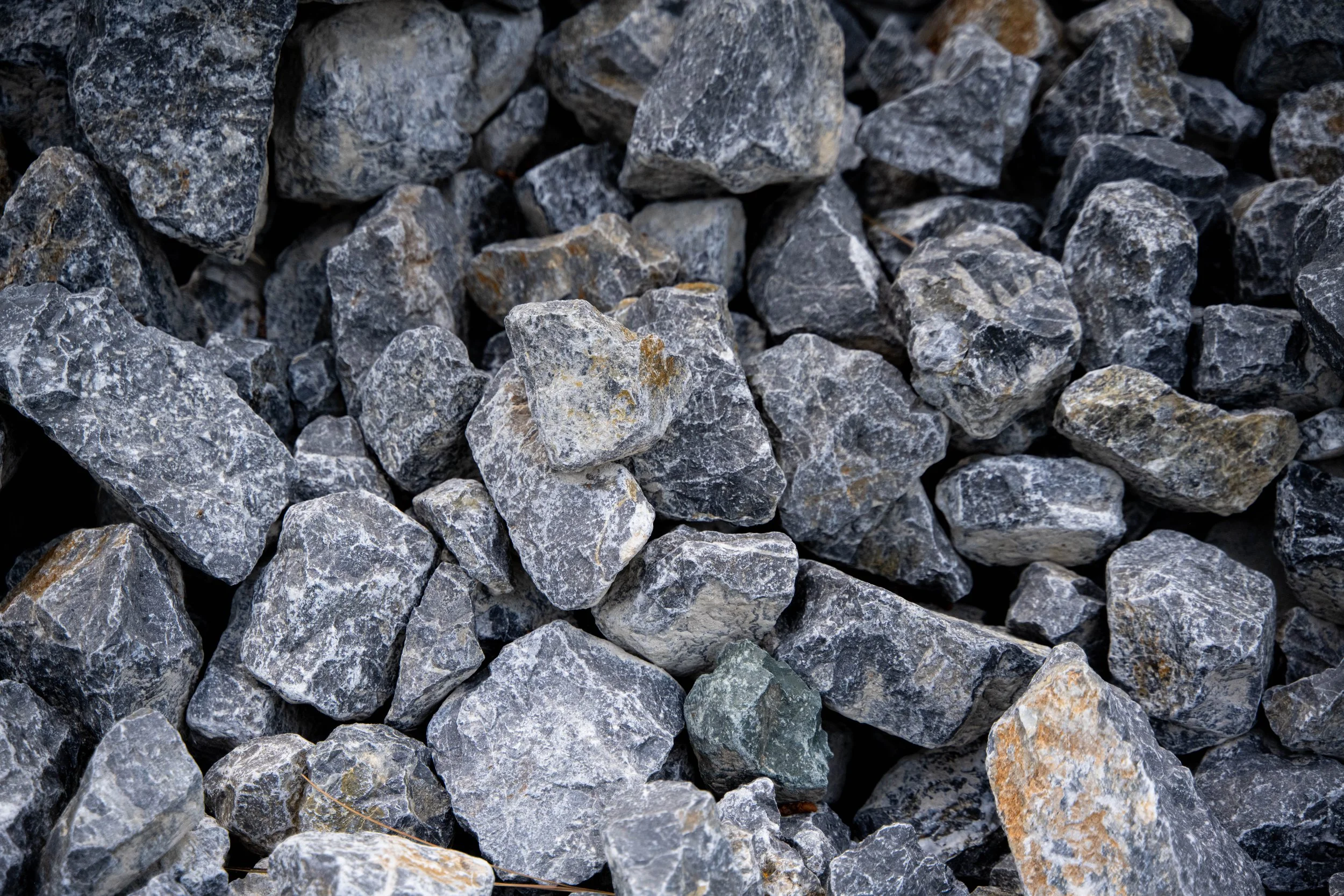 Close-up of gray and black rocks of various shapes and sizes.