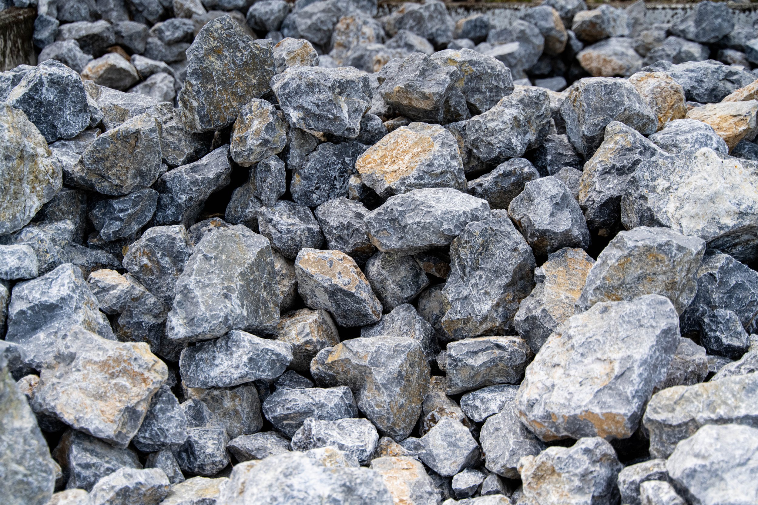 A close-up view of a pile of gray and tan rocks.