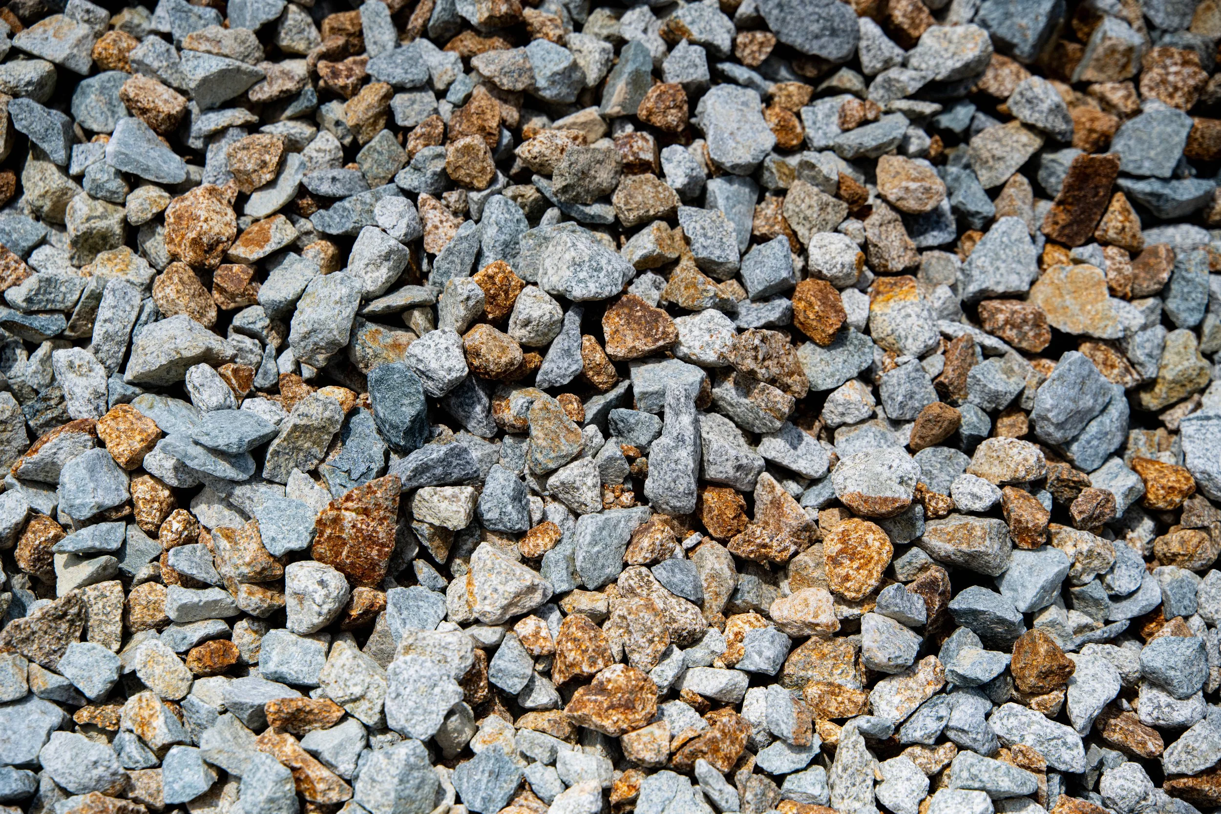 Close-up of a pile of small gray and brown gravel stones.