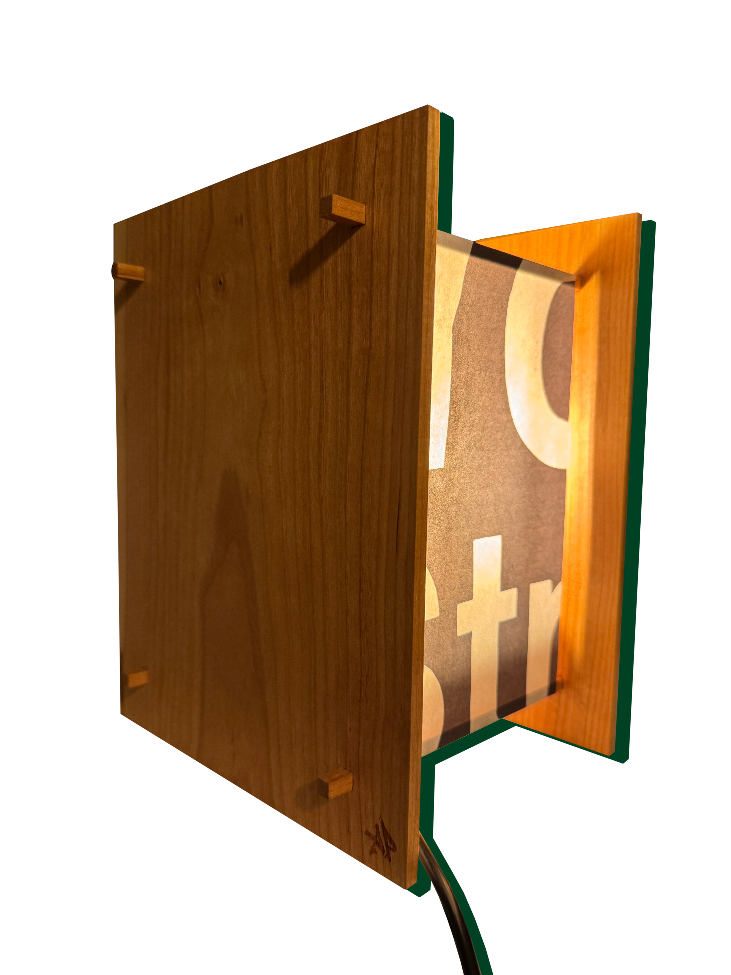A wooden Japanese clock with one side visible, featuring a black paper face with a warm light source and the brand logo at the bottom, connected by a black cord.