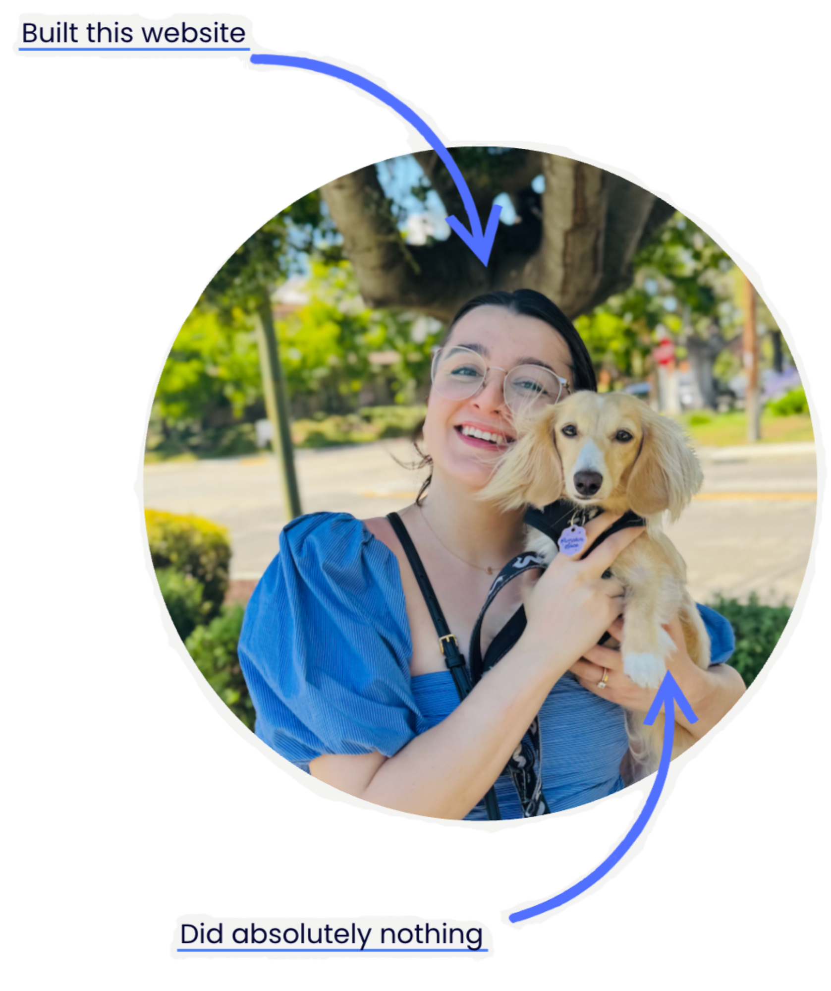 A woman with glasses and dark hair, smiling and holding a golden retriever puppy, standing outdoors with a large tree and green foliage in the background.