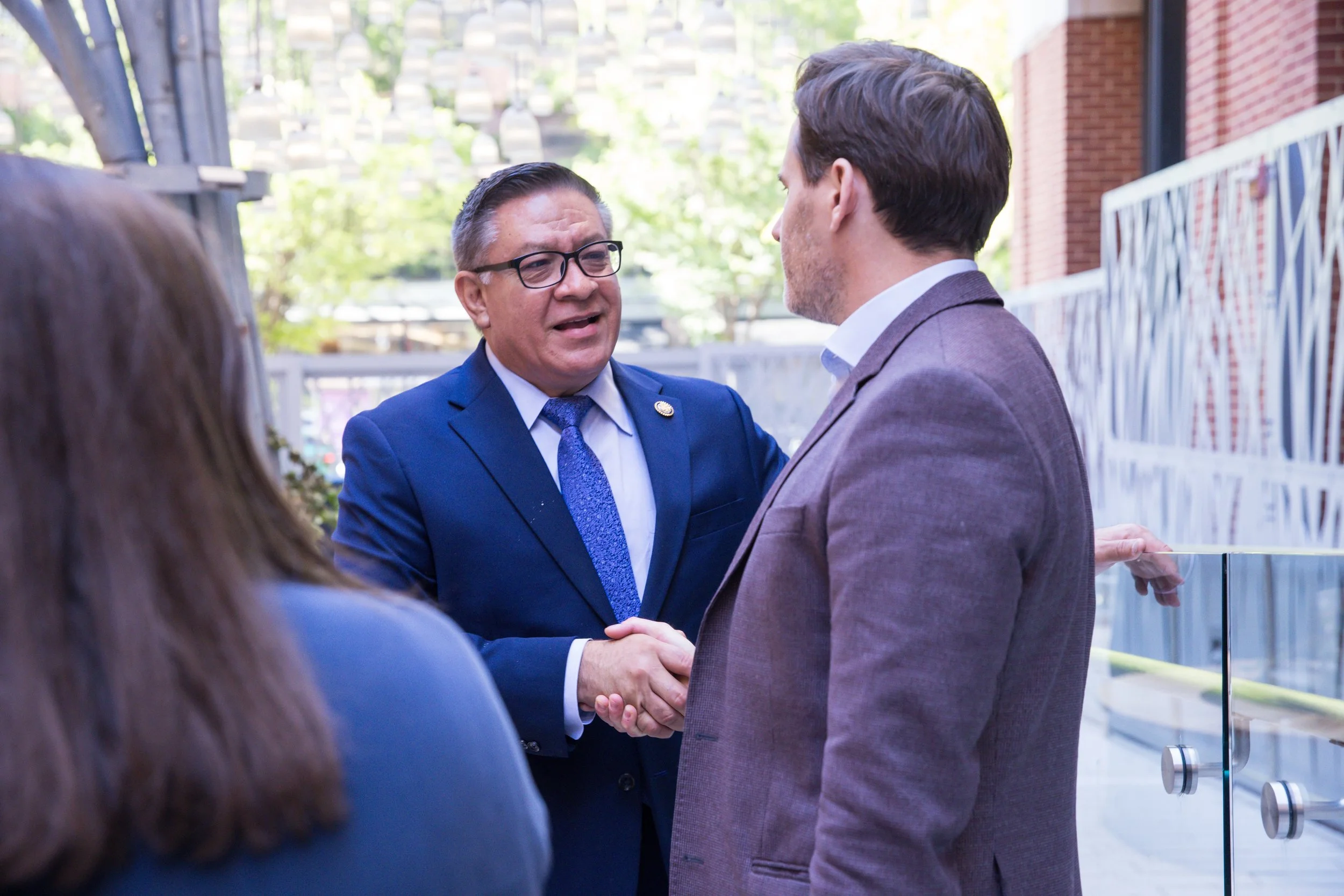 Rep. Salud Carbajal shakes hands with a man in a gray blazer