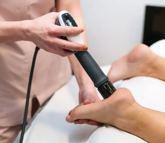 Person receiving Shockwave Therapy treatment on their foot for Plantar Fasciitis/Plantar heel pain