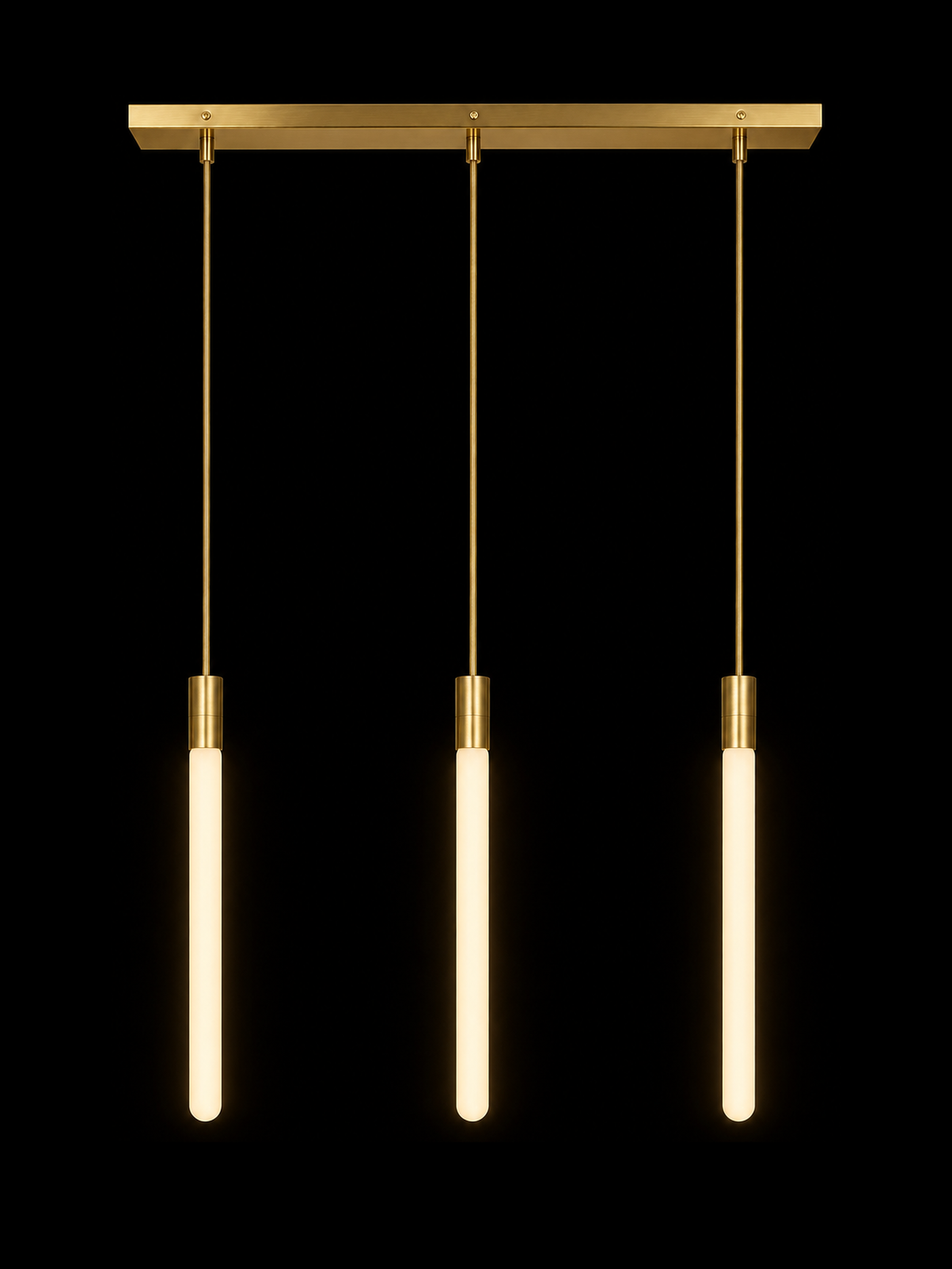Brass Runway, light on: three warm glowing vertical light tubes with brass fittings against black.