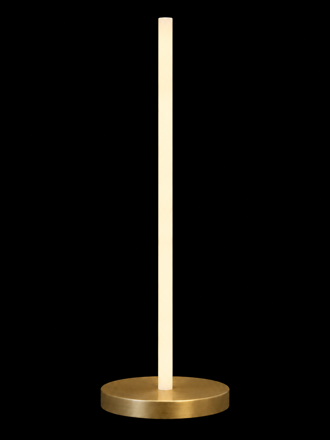 Eldon Trace Column lamp in brass, a warm white lit column on a round brass disc base.