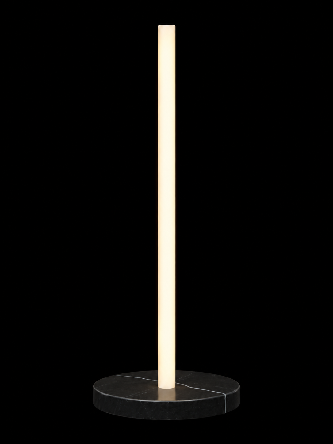 Eldon Trace Column lamp in black marble, a warm white lit column on a round black marble disc base.