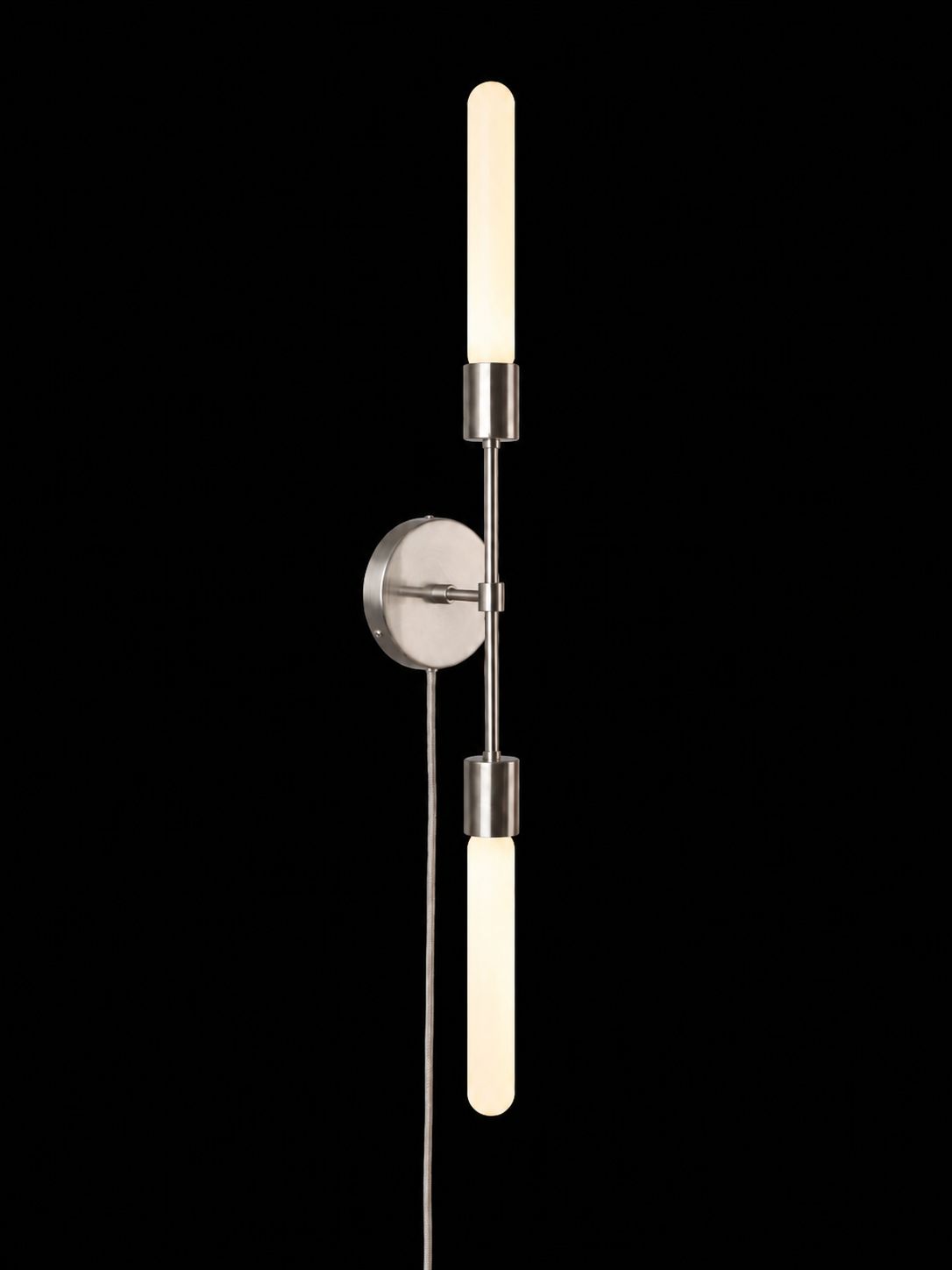 Eldon Trace Plus One double sconce in nickel, two bare bulbs on a slim arm with a round wall canopy and plug-in cord.