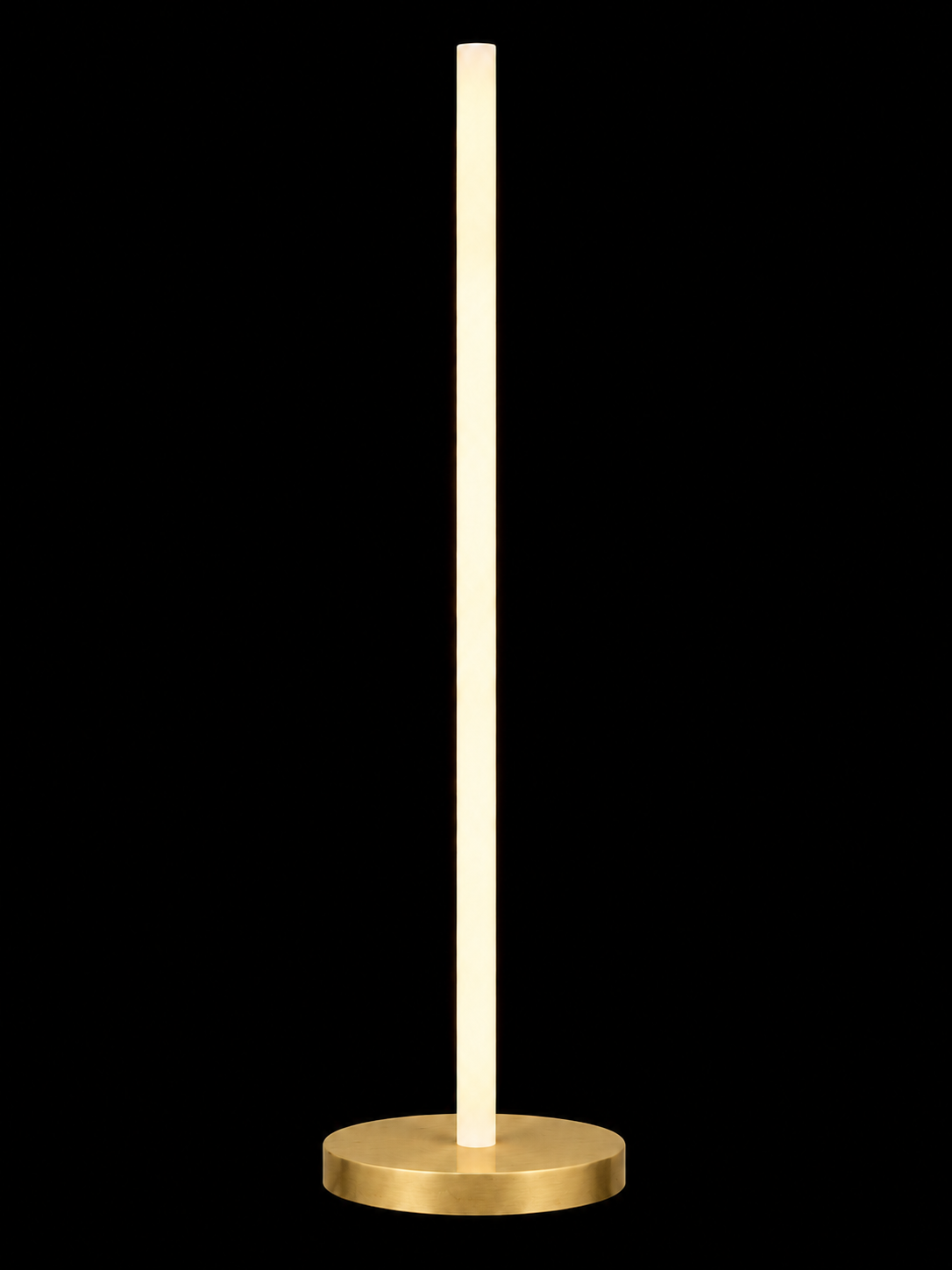 Eldon Trace Column lamp in brass, a warm white lit column on a round brass disc base.