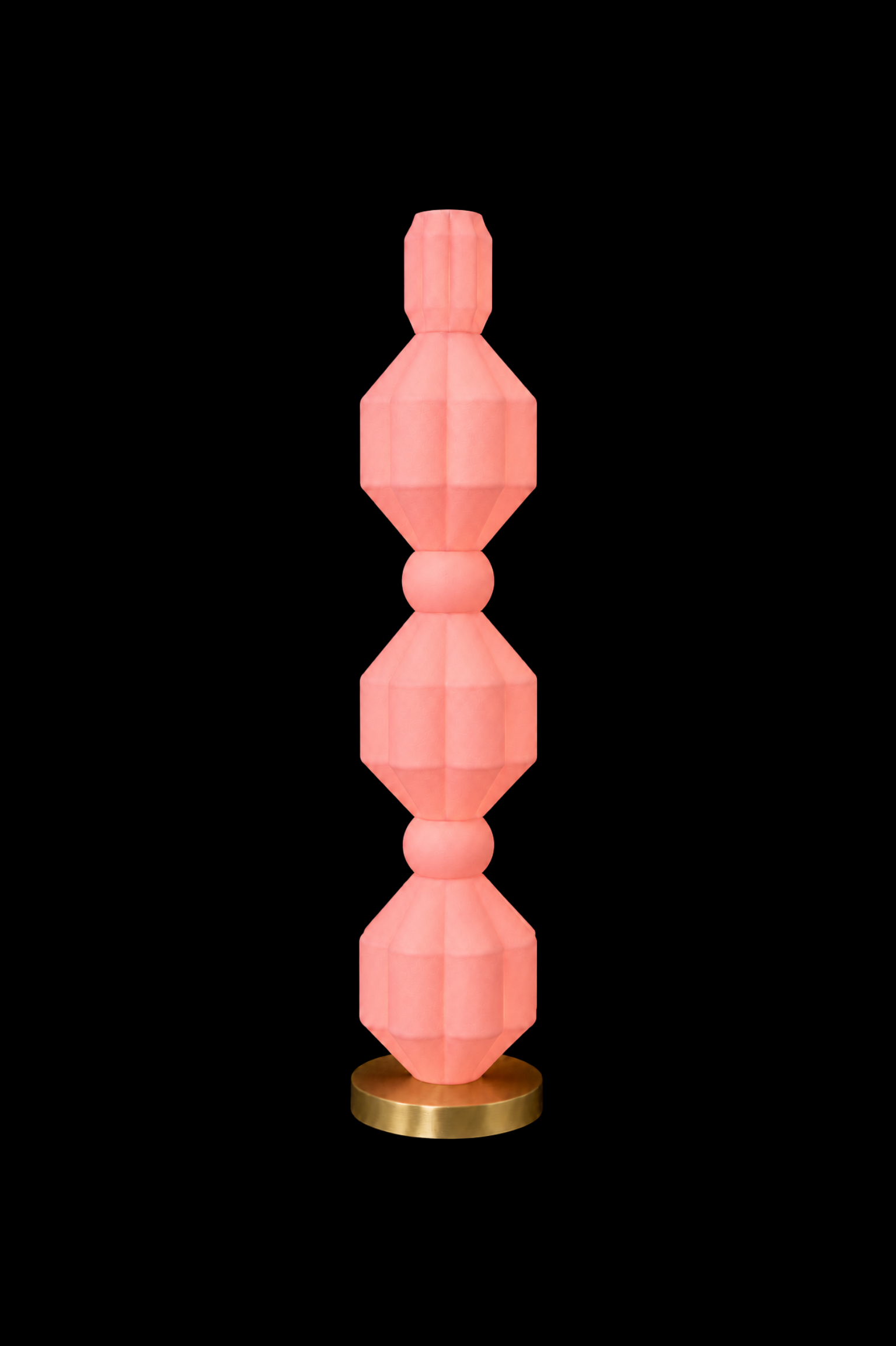 Eldon Trace Elaine lamp in pink, a warm pink lit column on a round brass base.