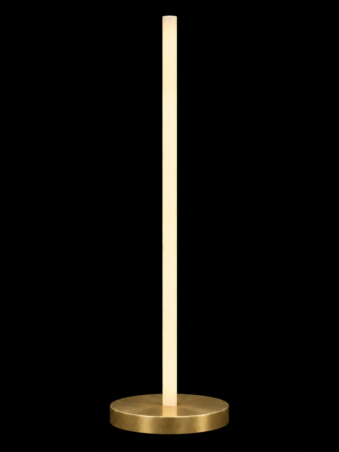 Eldon Trace Column lamp in brass, a warm white lit column on a round brass disc base.