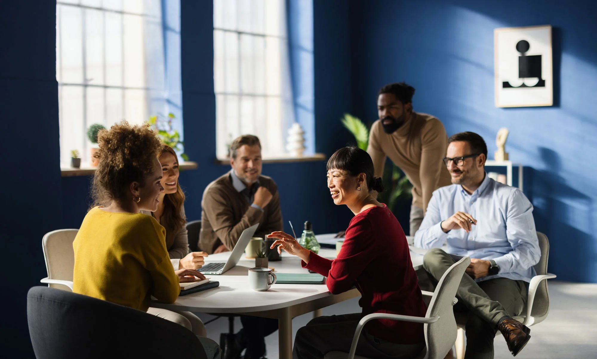 A diverse team collaborating in a modern office, reflecting Growth Mode's commitment to diverse and high-impact hiring for fast-growing tech startups.