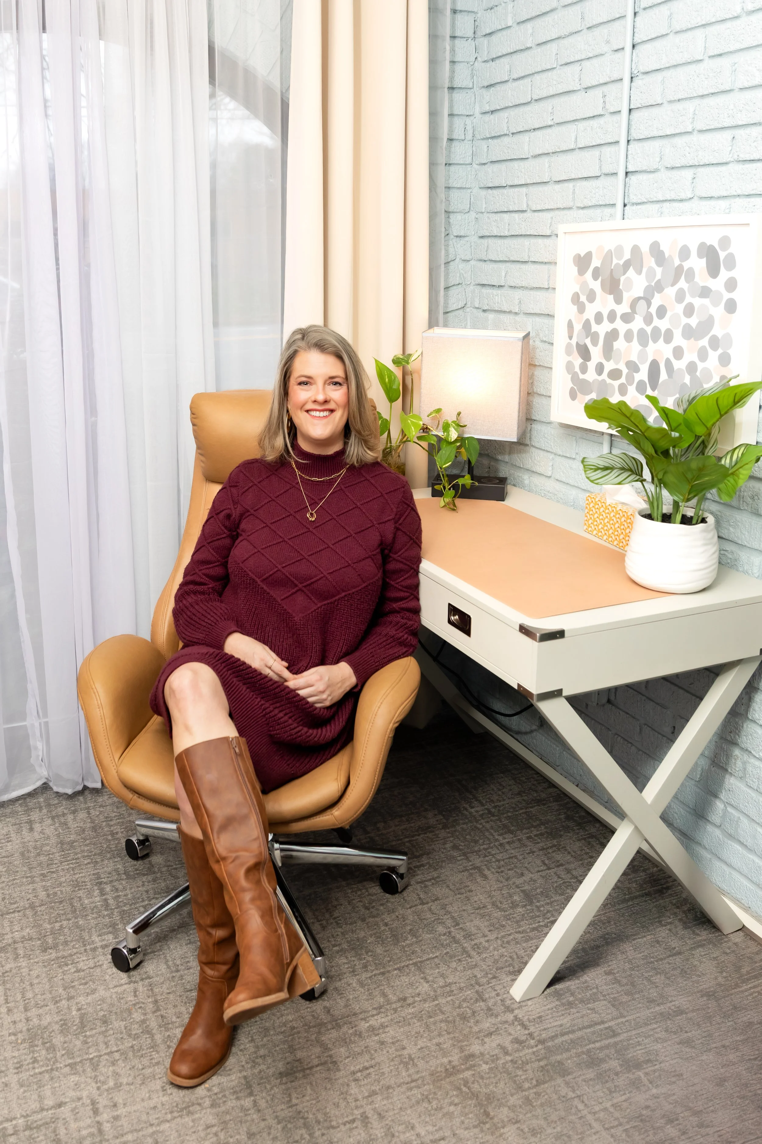 Litzie Hassell, LPC, LCMHC in a desk chair in her office in Atlanta, GA.