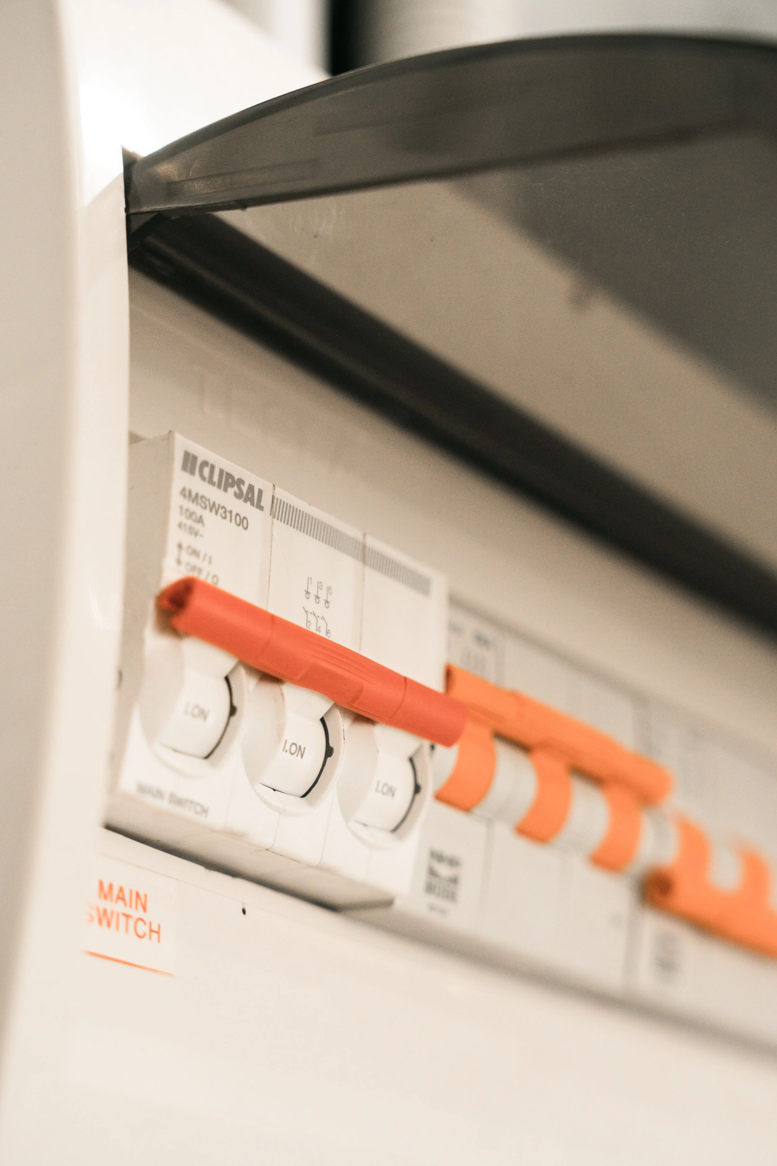 Close-up of an electrical fuse box with circuit breakers labeled 'I ON' and 'LOW' in an electrical panel.