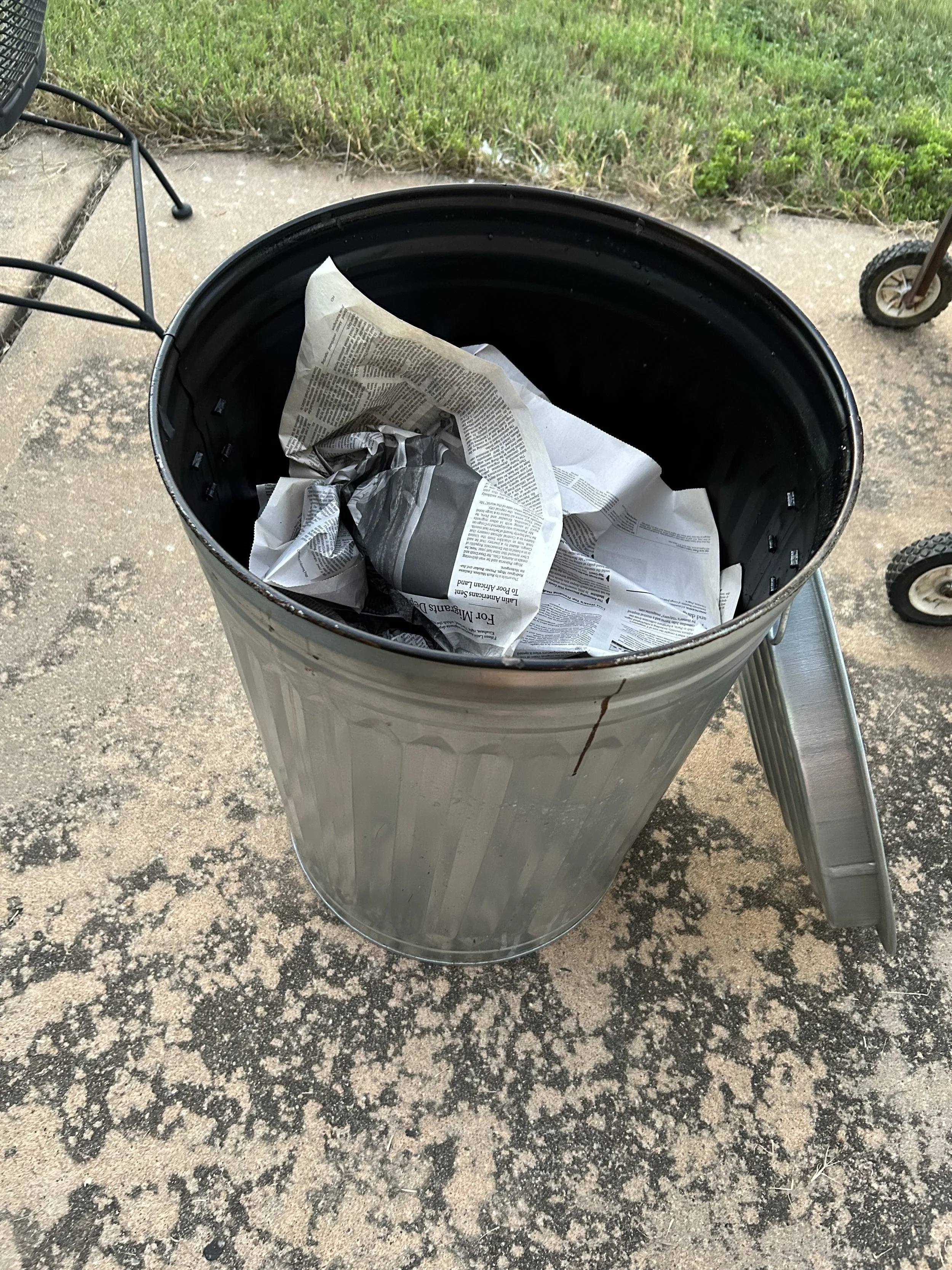 After removing the sculpture from the kiln (using a long pair of tongs and welding gloves), I place it into a reduction bin.  It catches fire and the lid is put on.  This removes the oxygen and lets the piece smolder, creating smoke patterns and glaz