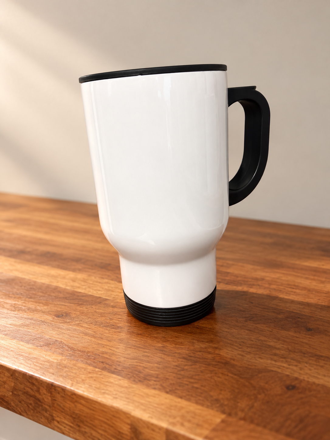 White travel mug on warm wood.png
