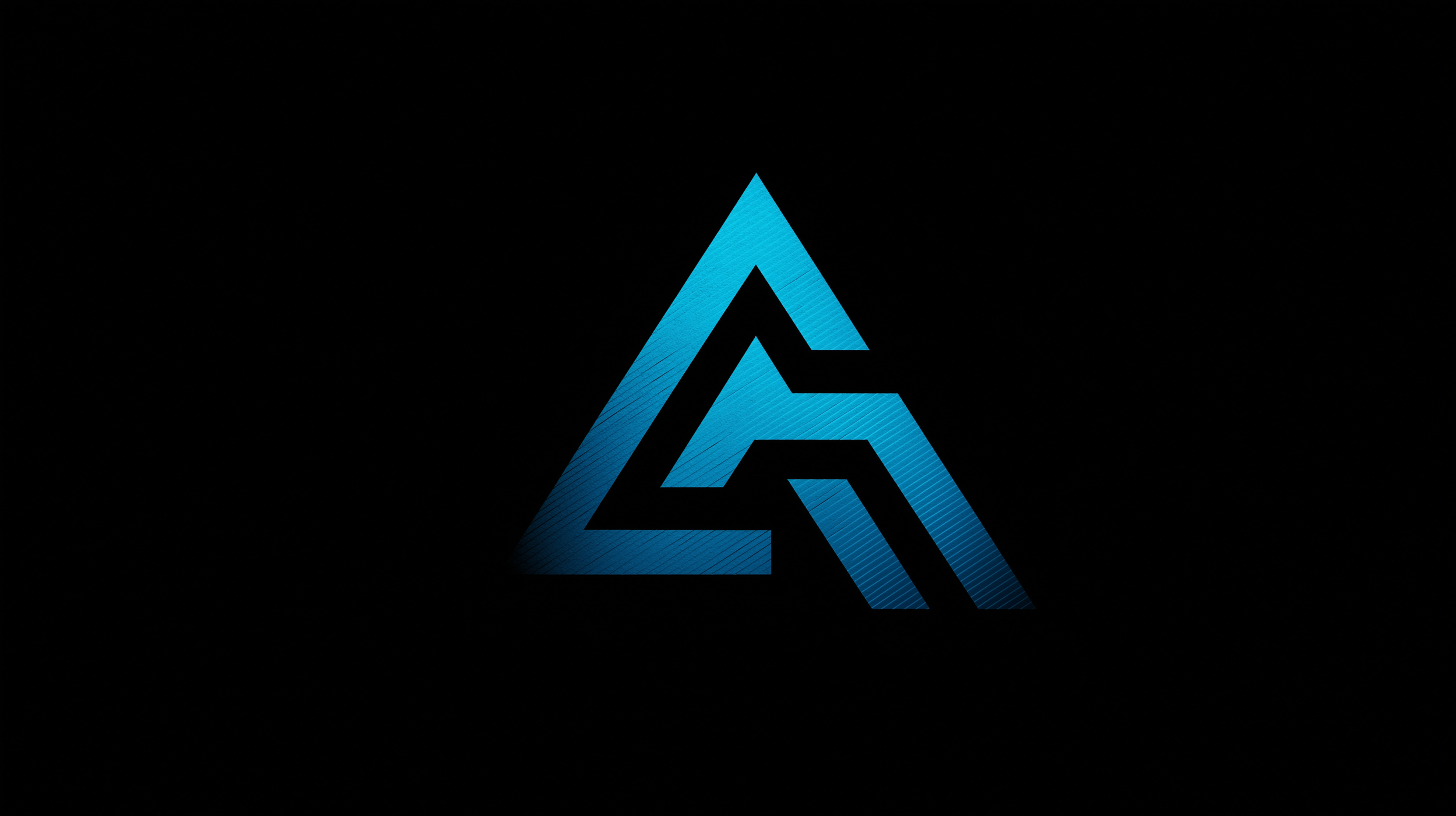 A stylized geometric logo with blue and black elements on a dark background.