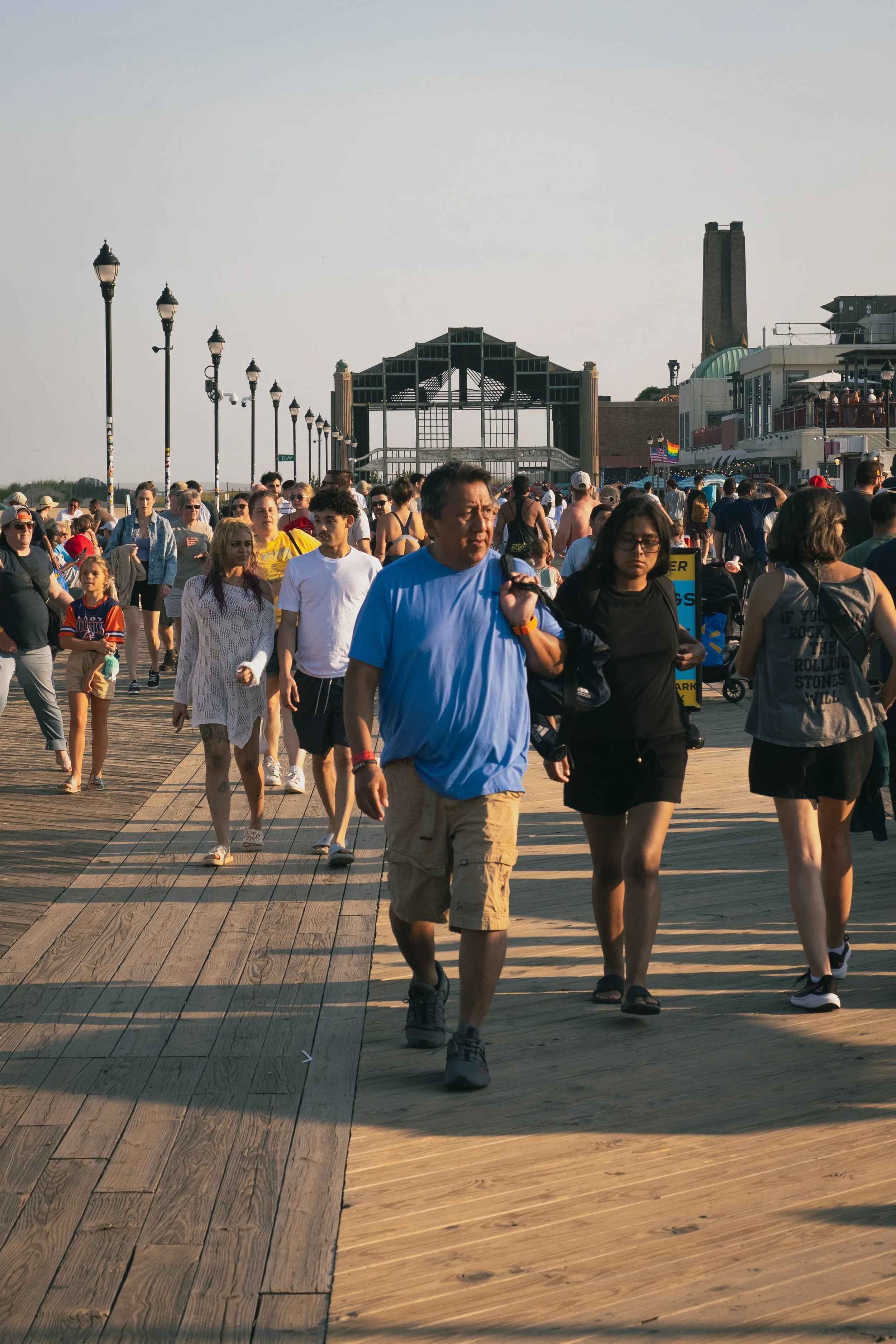 A man walks down the Asbury Park boardwalk at sundown