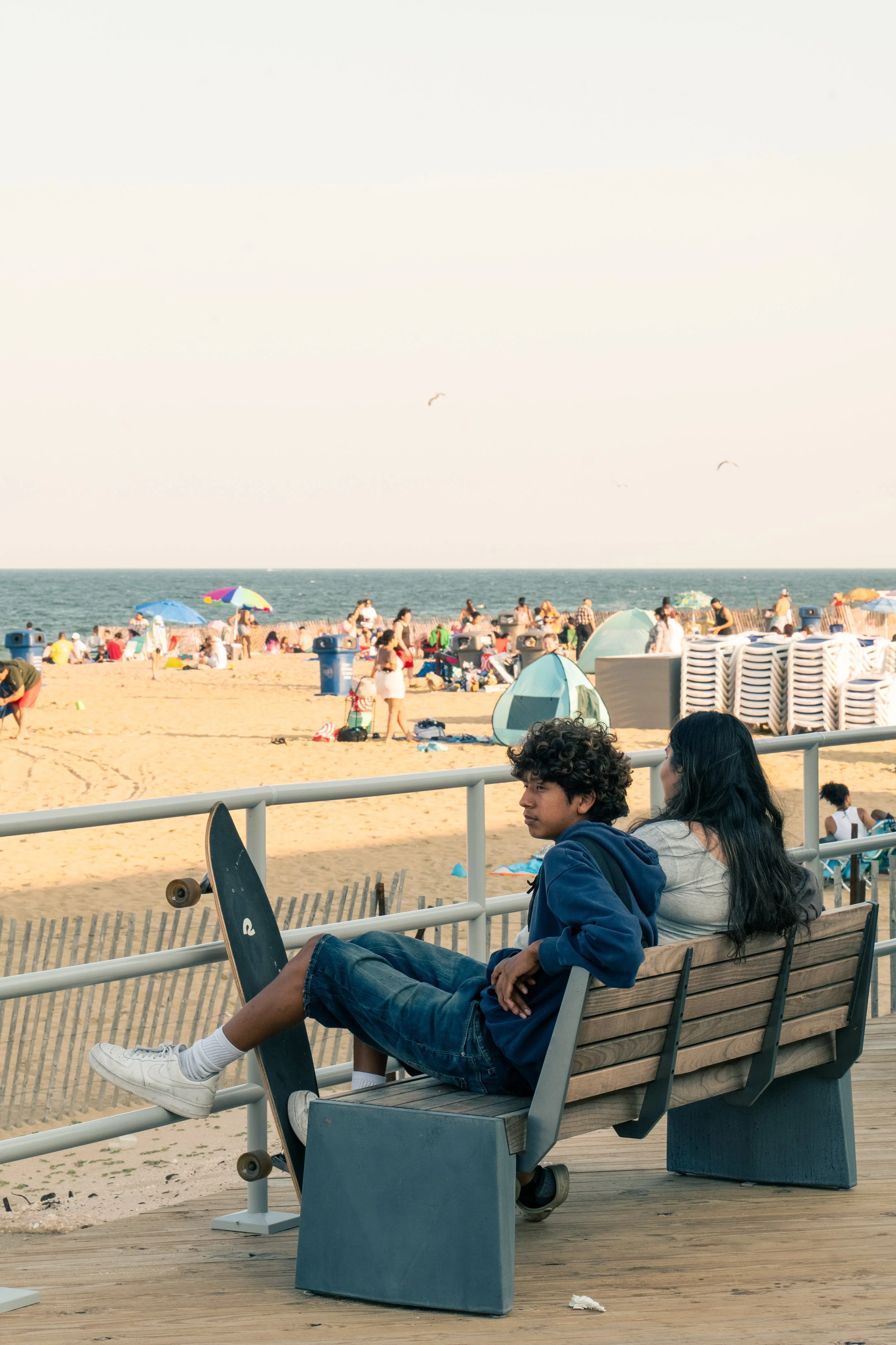 At the Asbury Park Boardwalk, a skater takes a second to relax on a bench