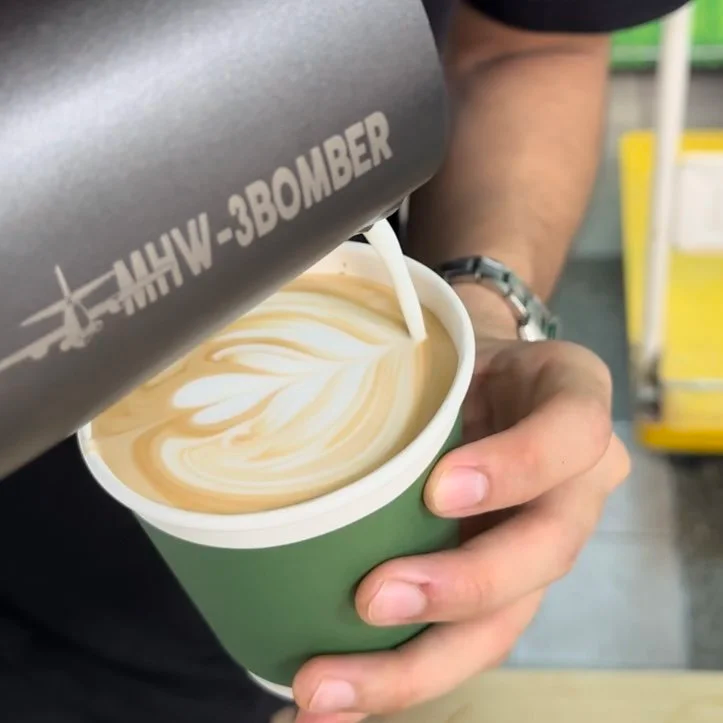Barista pouring professional latte art during a Simple Brewings event catering service.