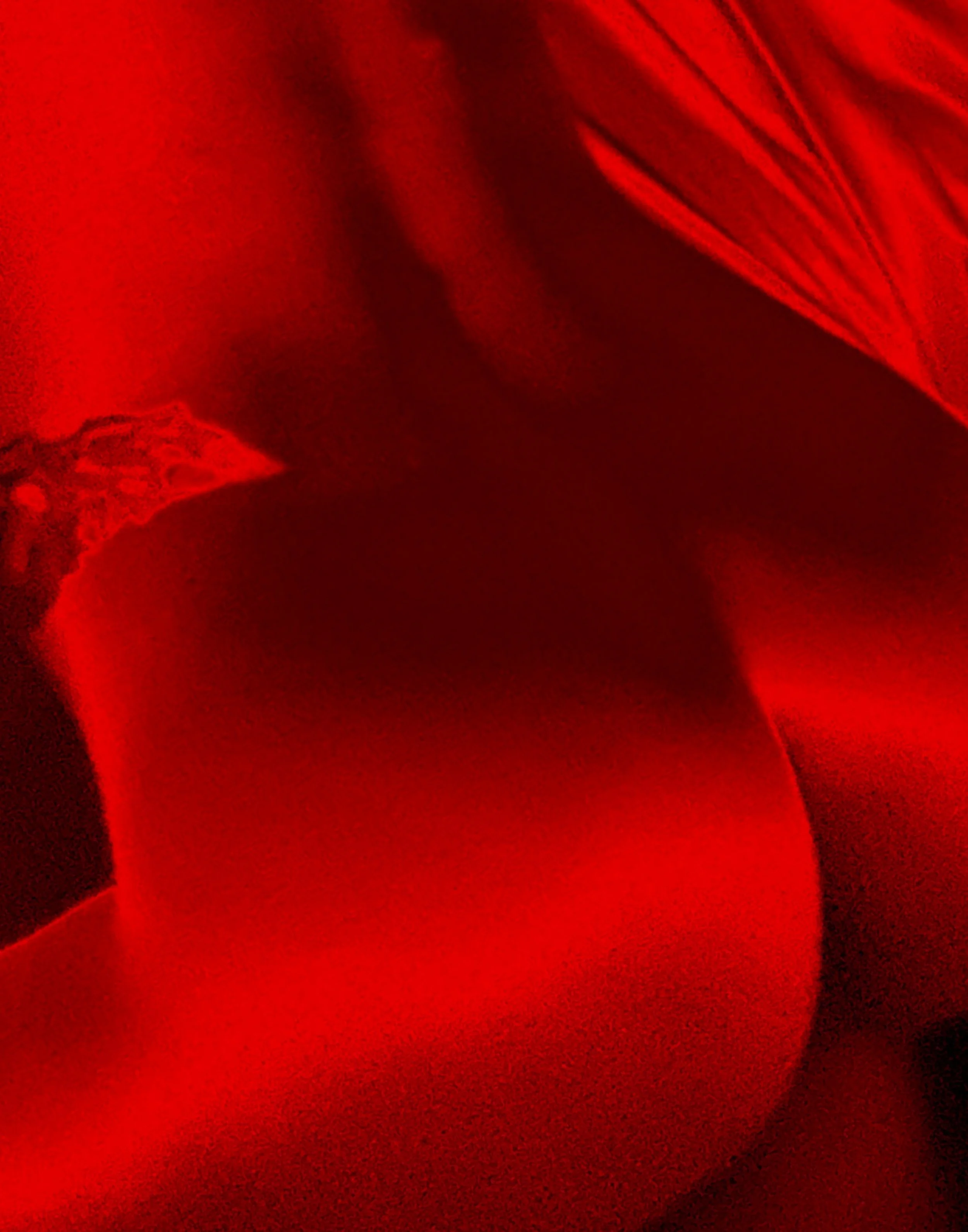 A woman lying on a bed in a dark room illuminated by red lighting, A red aesthetic nude figure photograph featuring a woman in an erotic pose, with red lighting.