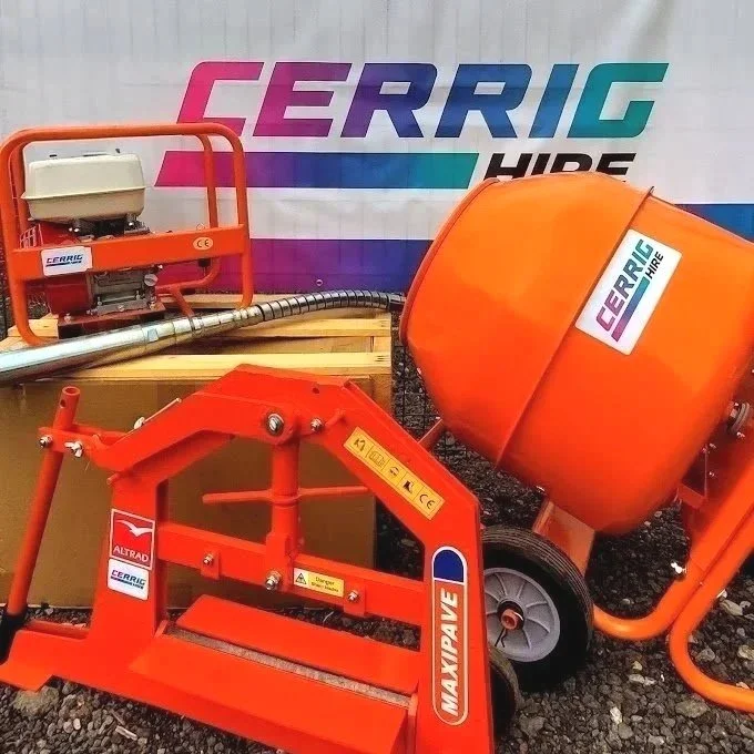 Construction equipment and machinery from Cerrig Hire, including an orange concrete mixer, an engine or motor device, and a mixing or conveying attachment, with a Cerrig Hire banner in the background.
