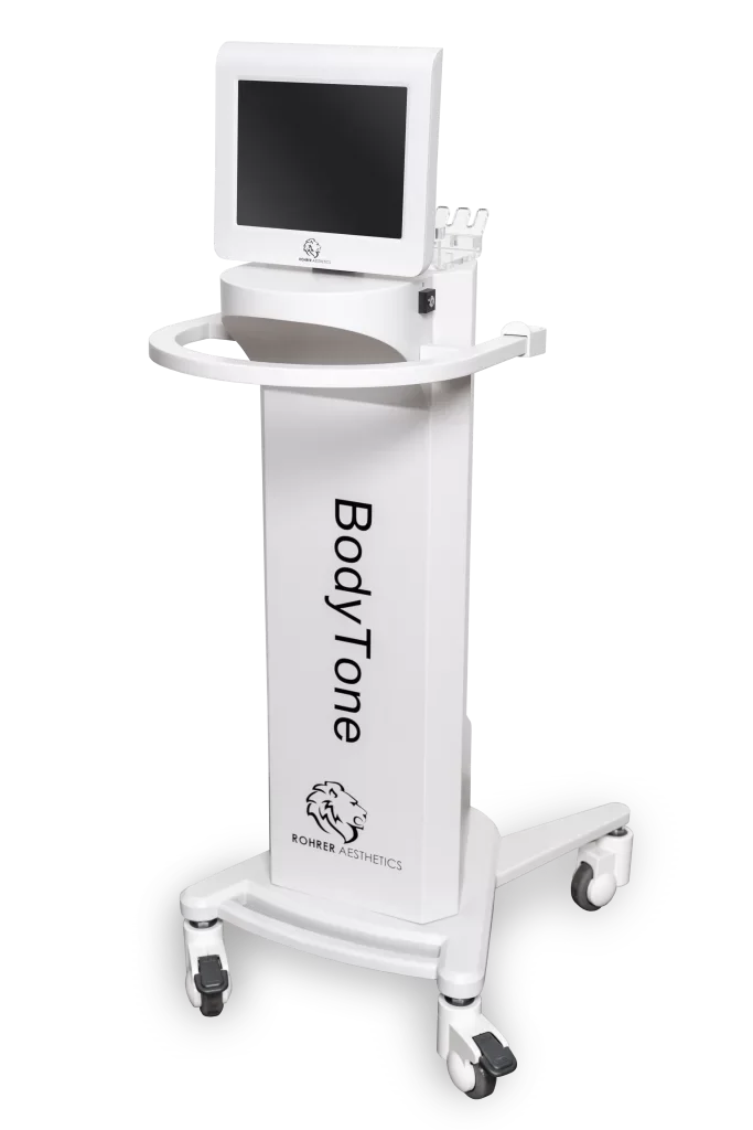 Medical device on wheels labeled 'Body/Tone' with a computer monitor mounted on top, branded with 'Rohrer Aesthetics' logo and lion head emblem.