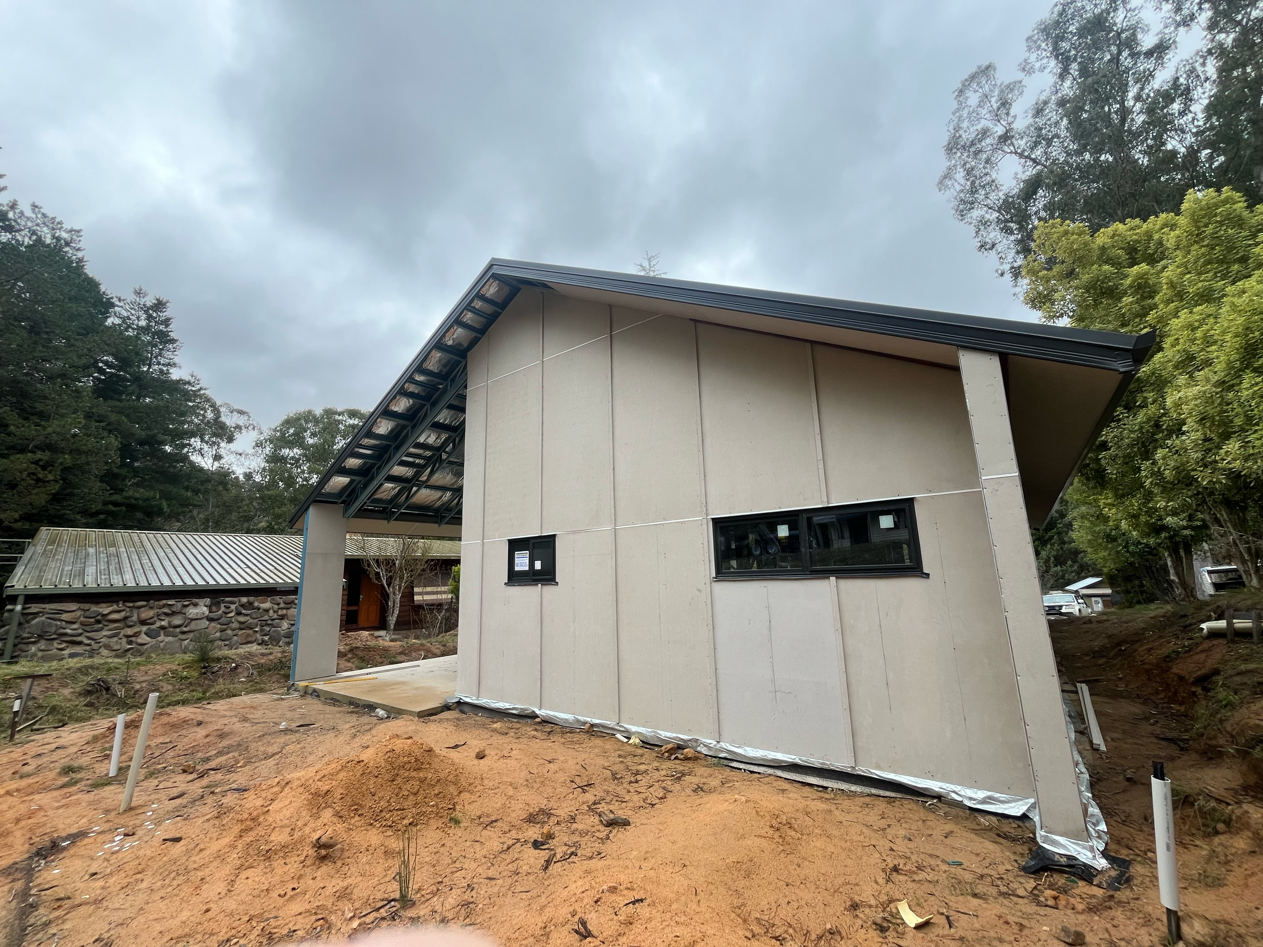 Side of the Mansfield Alpine home with cladding fitted and windows installed