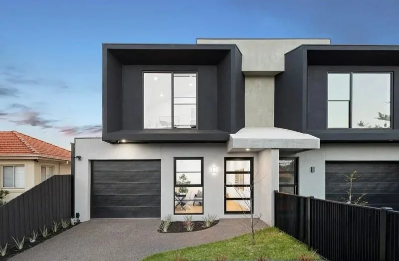 Front of the Bentleigh townhouse with black-framed upper level and garage