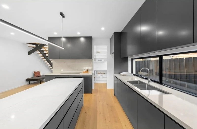 Stone island bench and black cabinetry, Bentleigh townhouse