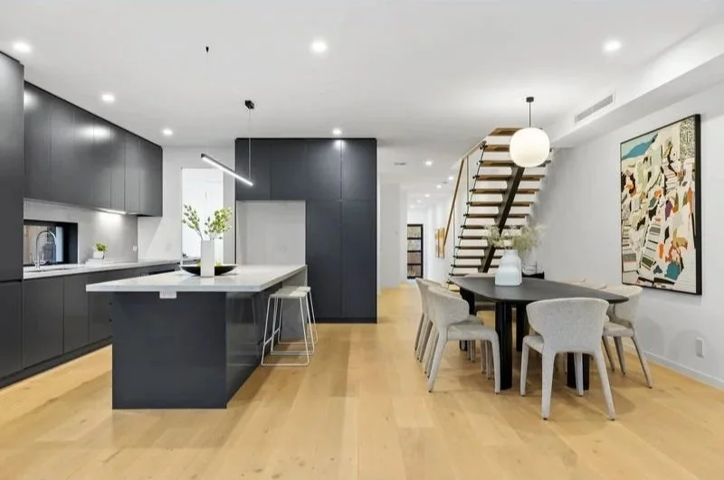 Kitchen, dining and floating timber staircase, Bentleigh townhouse