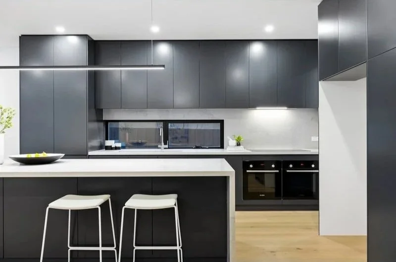 Kitchen with stone benchtops and twin ovens, Bentleigh townhouse