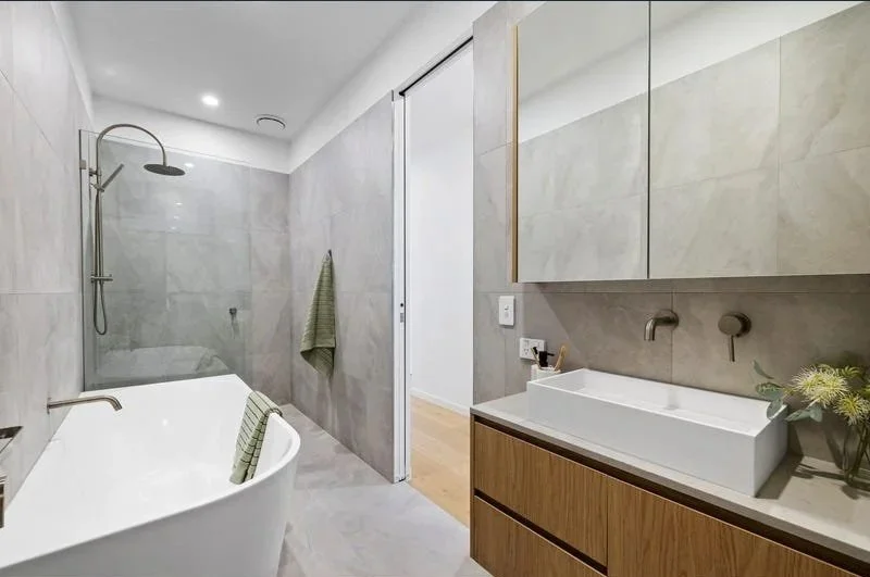 Family bathroom with bath and timber vanity, Bentleigh townhouse