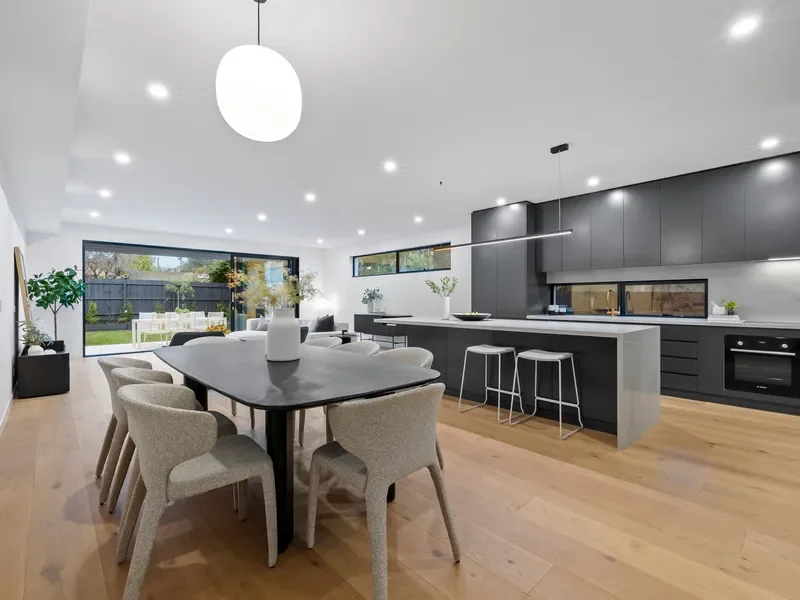 Dining area beside the kitchen and stacking doors, Bentleigh townhouse