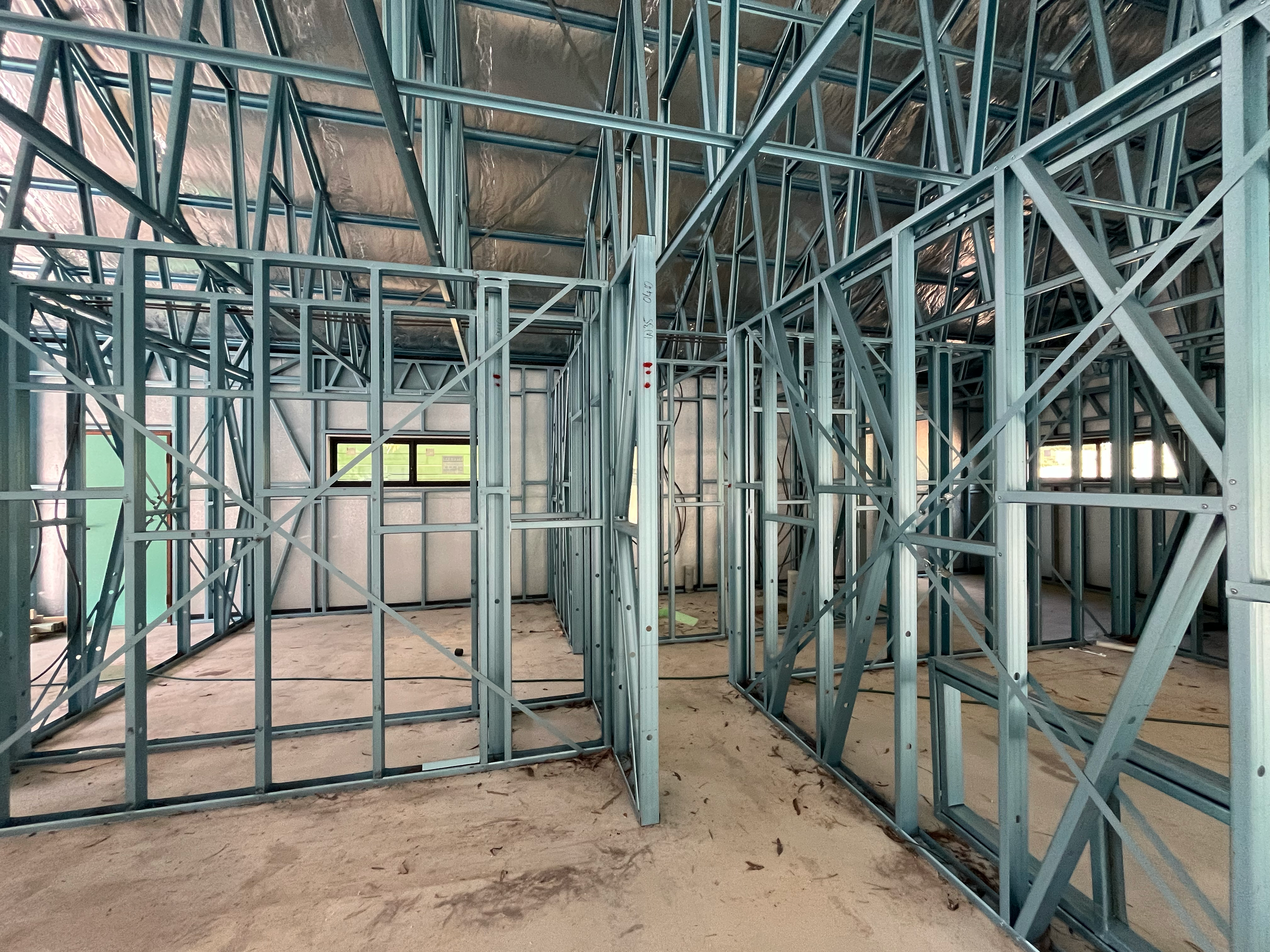 Internal steel wall frames dividing the rooms of the Mansfield Alpine home